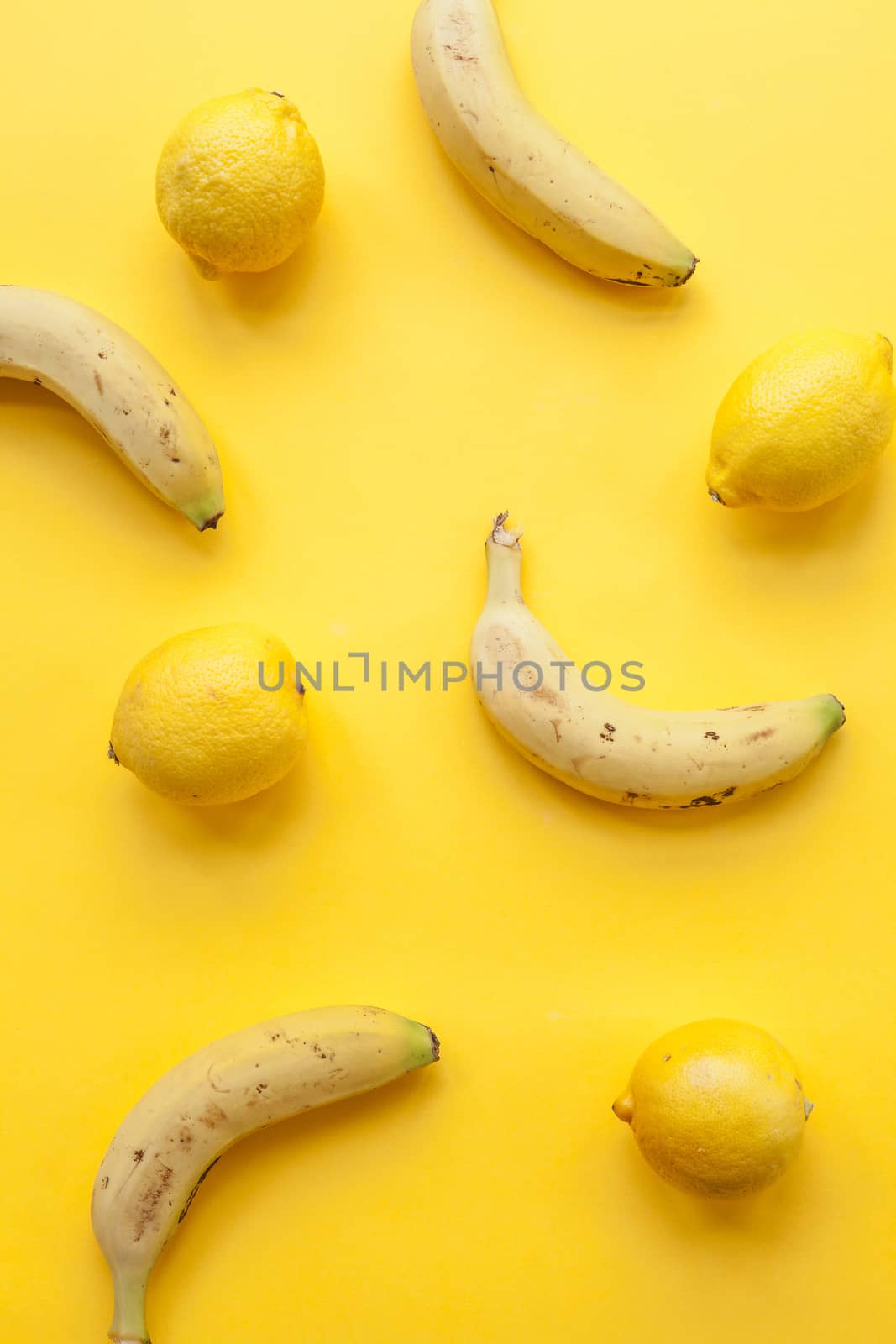 Peel banana and fruit and lemons  on a yellow background and colorful background