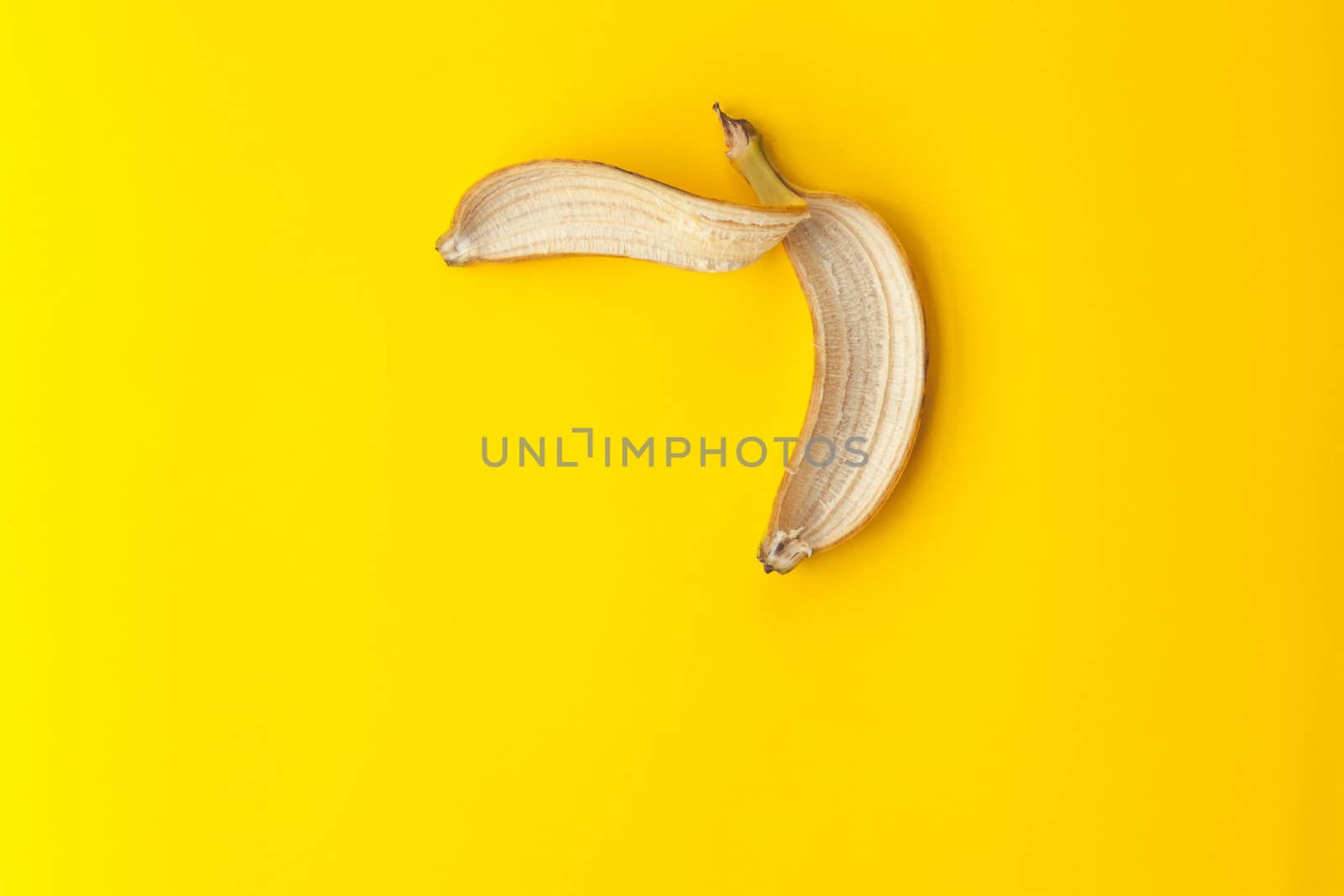 Peel banana on a yellow background by andongob