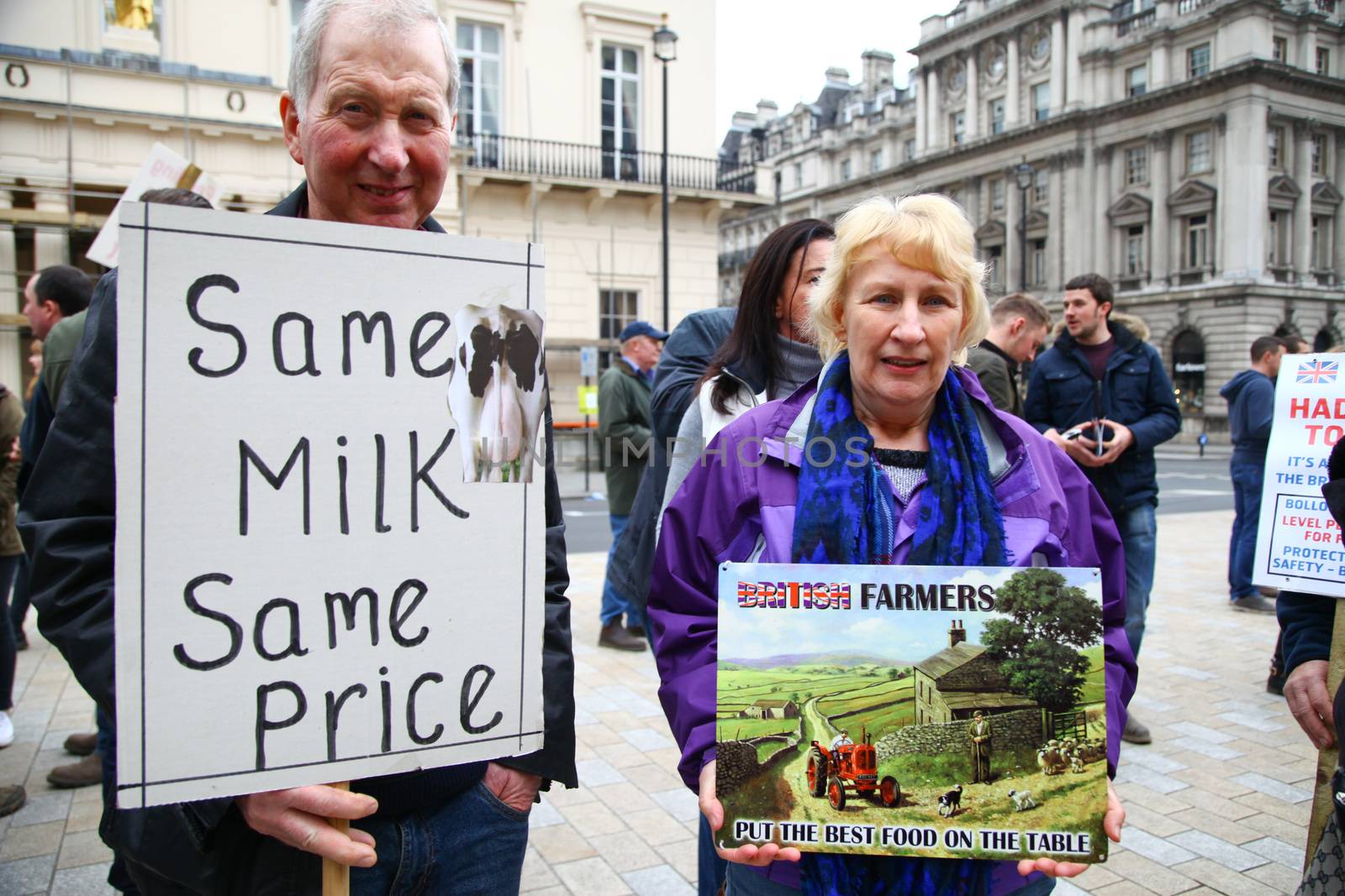 ENGLAND, London: Demonstrators hold up signs during a farmers rally in London, on March 23, 2016. The march intends to raise awareness, as many farmers across the region are facing an economic crisis. Participants gathered at Waterloo Place and marched to Downing Street. The event was organized by the Farmers For Action (FFA).