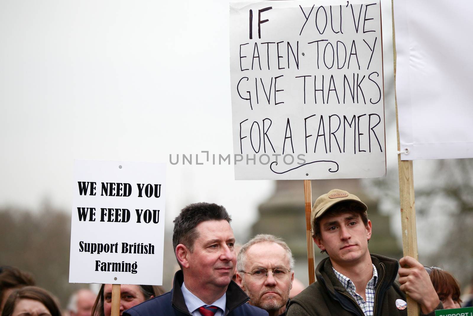 ENGLAND, London: Demonstrators hold up signs during a farmers rally in London, on March 23, 2016. The march intends to raise awareness, as many farmers across the region are facing an economic crisis. Participants gathered at Waterloo Place and marched to Downing Street. The event was organized by the Farmers For Action (FFA).