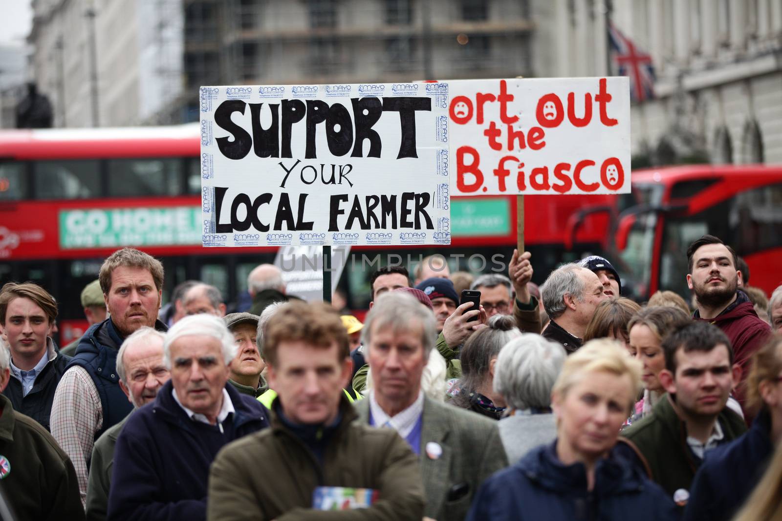 ENGLAND, London: Demonstrators hold up signs during a farmers rally in London, on March 23, 2016. The march intends to raise awareness, as many farmers across the region are facing an economic crisis. Participants gathered at Waterloo Place and marched to Downing Street. The event was organized by the Farmers For Action (FFA).