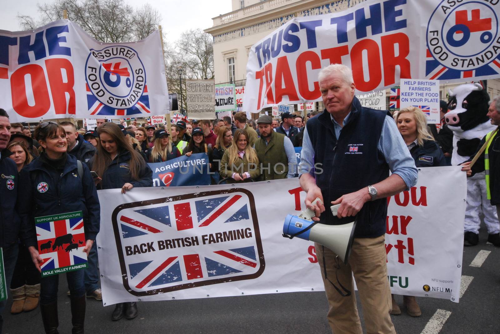 UNITED KINGDOM, London: Protesters stand behind a banner which reads Back British Farming during a demonstration of English farmers to British Prime Minister office in Downing Street in London on March 23, 2016 to protest against the low cost prices of agricultural product.