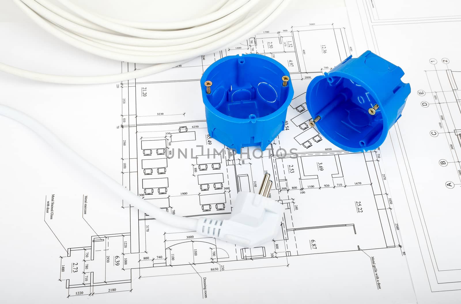 Architecture plan and rolls of blueprints with plug and blue plastic covers. Building concept