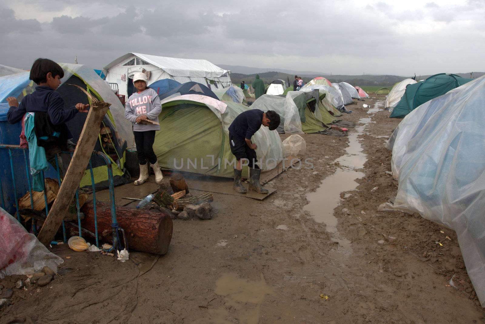 GREECE, Idomeni: Thousands of migrants are stranded in a makeshift camp for migrants and refugees at the Greek-Macedonian border near the village of Idomeni on March 23, 2016. The UN refugee agency harshly criticized an EU-Turkey deal on curbing the influx of migrants to Greece, saying reception centers had become detention facilities, and suspended some activities in the country. The EU and Ankara struck a deal aiming to cut off the sea crossing from Turkey to the Greek islands that enabled 850,000 people to pour into Europe last year, many of them fleeing the brutal war in Syria.