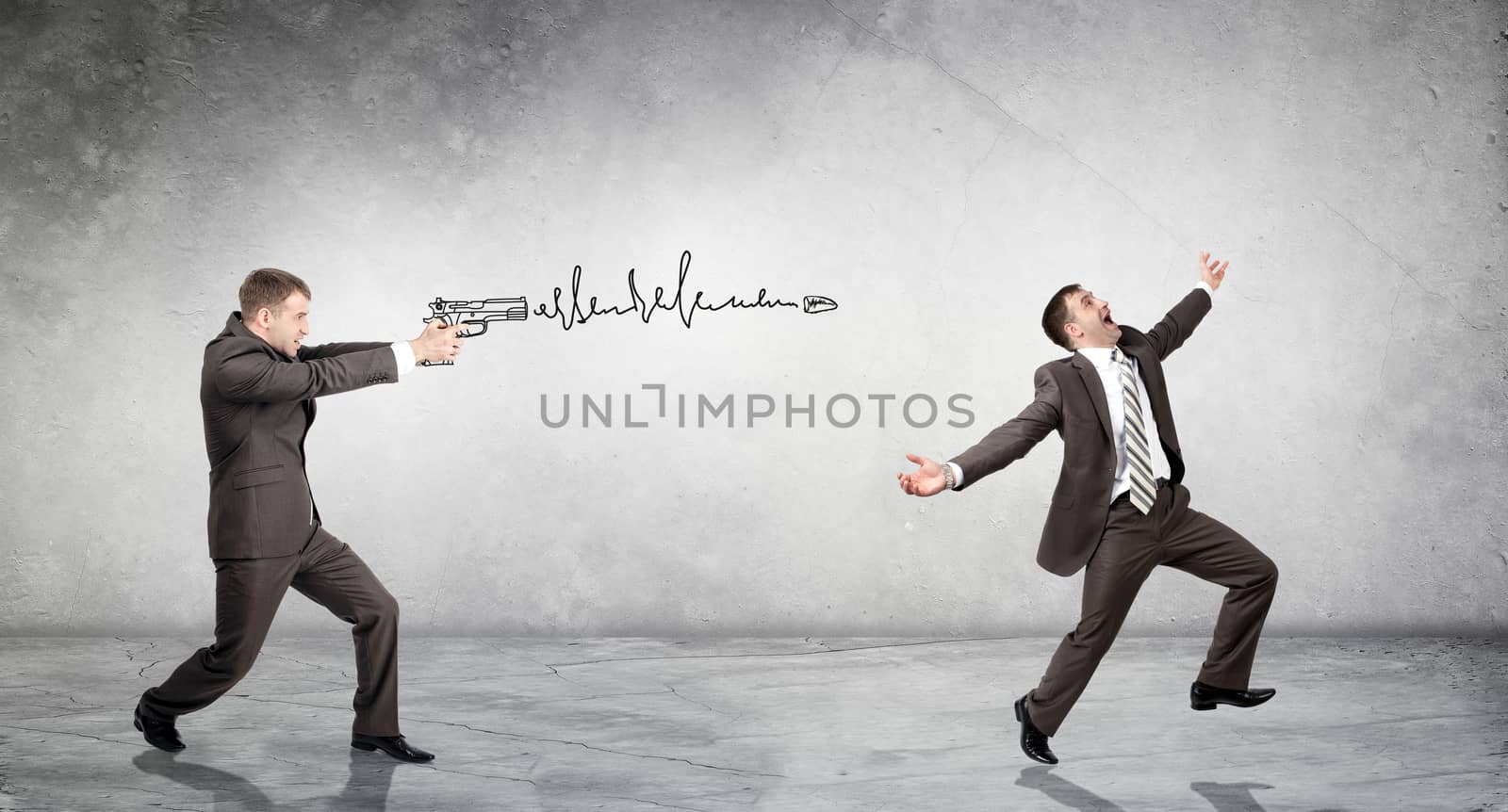 Businessman shooting  another man on grey wall background