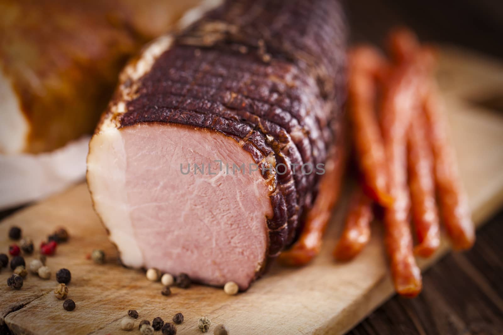 Delicious ham on wooden desk closeup, studio shot