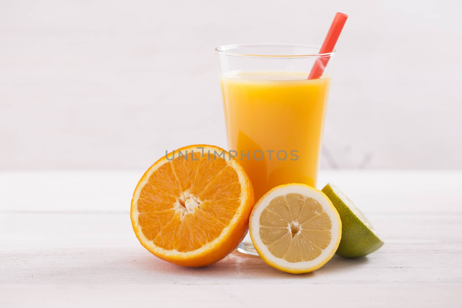 Healthy and fresh mixed juice from fruits on white wooden table