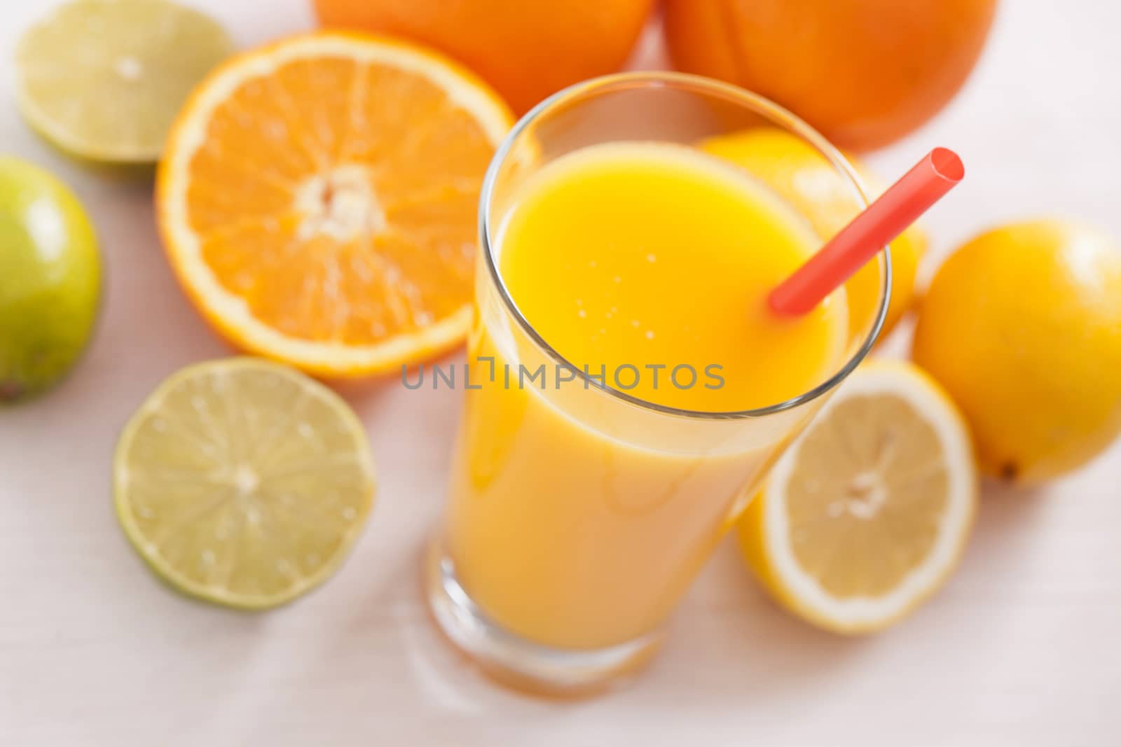 Healthy and fresh mixed juice from fruits on white wooden table