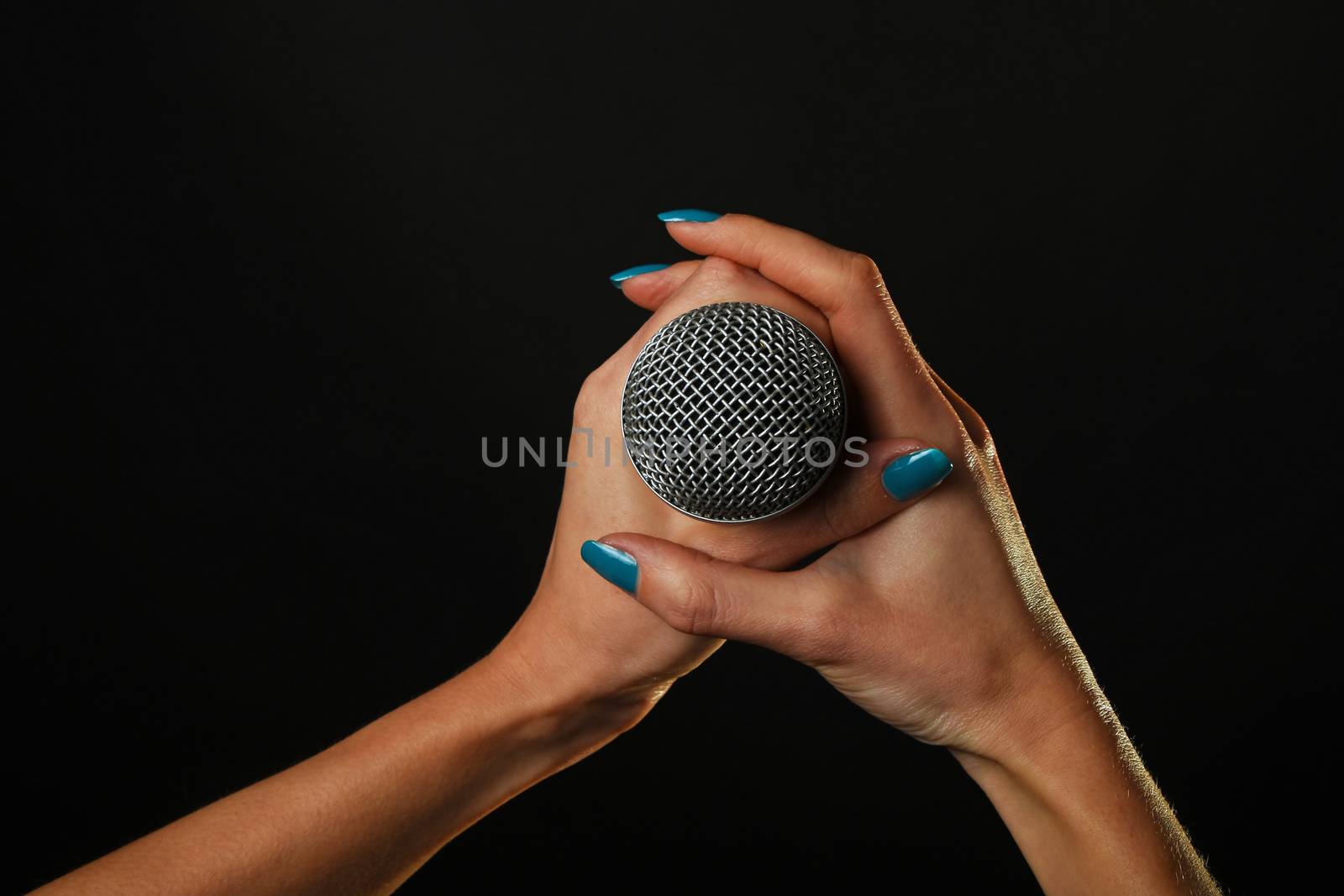 Woman hands with microphone isolated on black by BreakingTheWalls