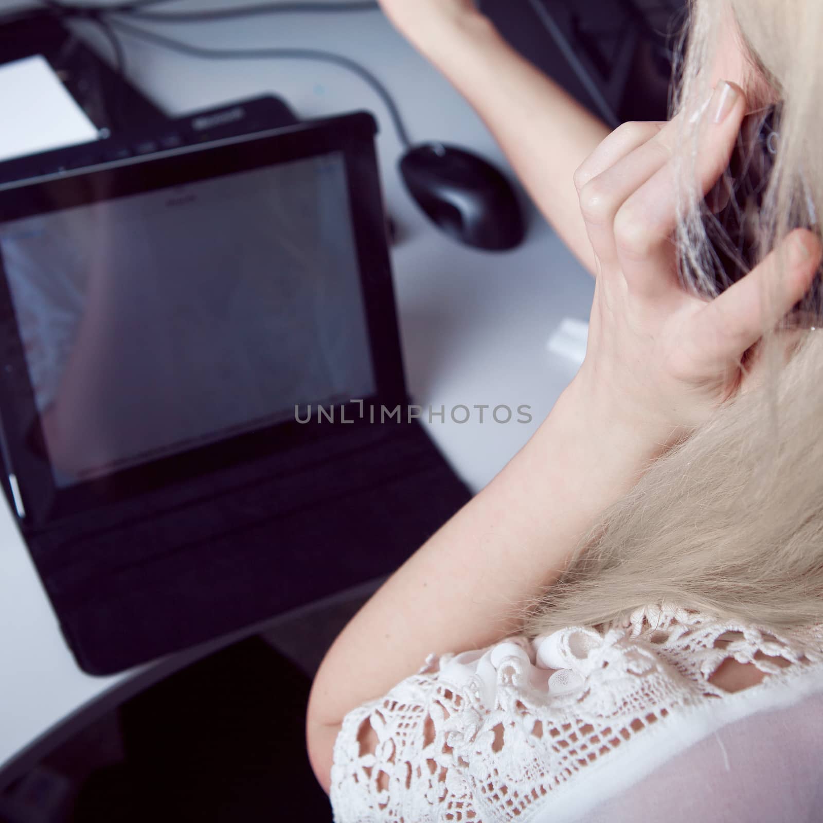 business woman talking on the phone at work and working on tablet