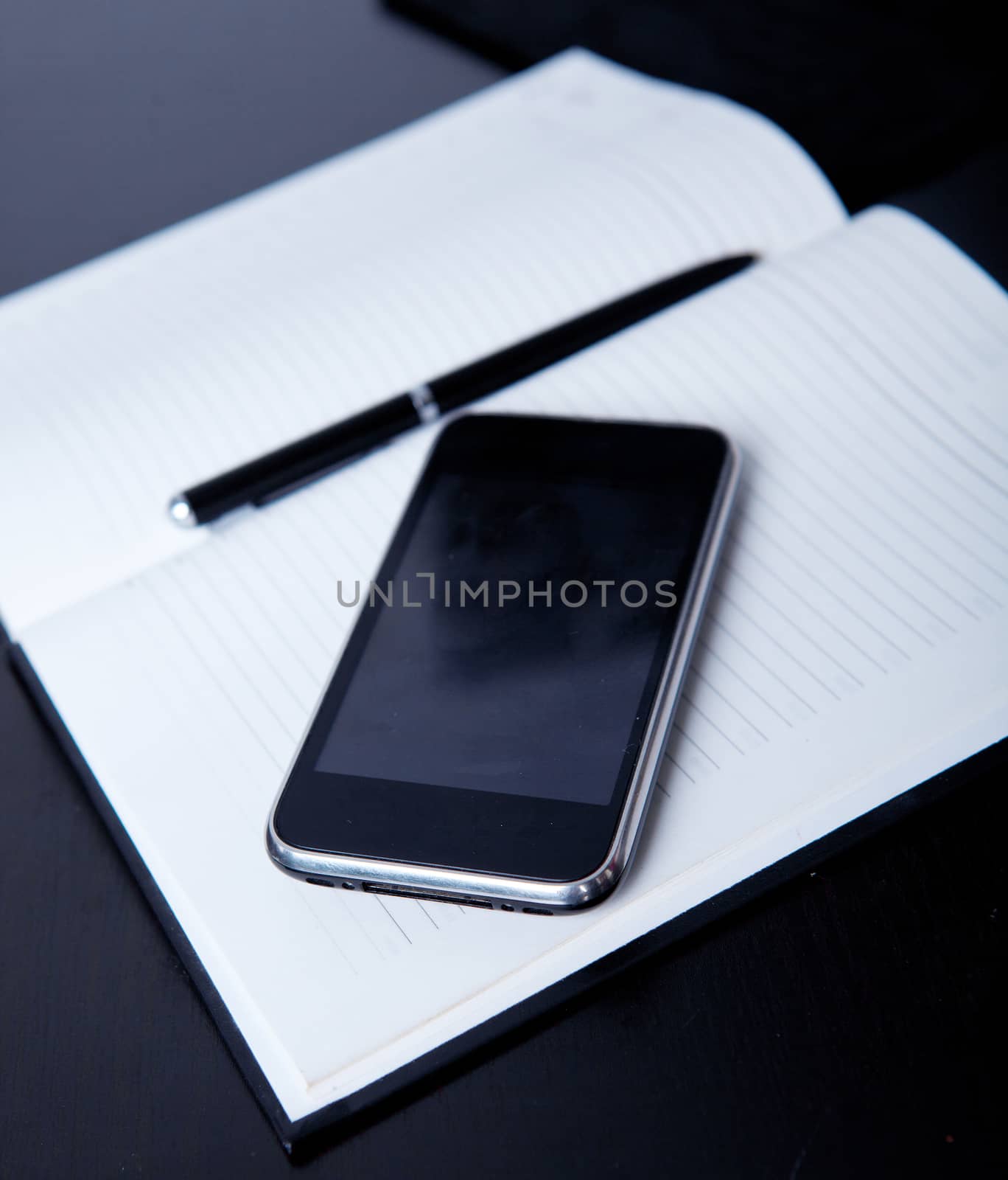 Workplace business person: diary, on the background of the phone by traza