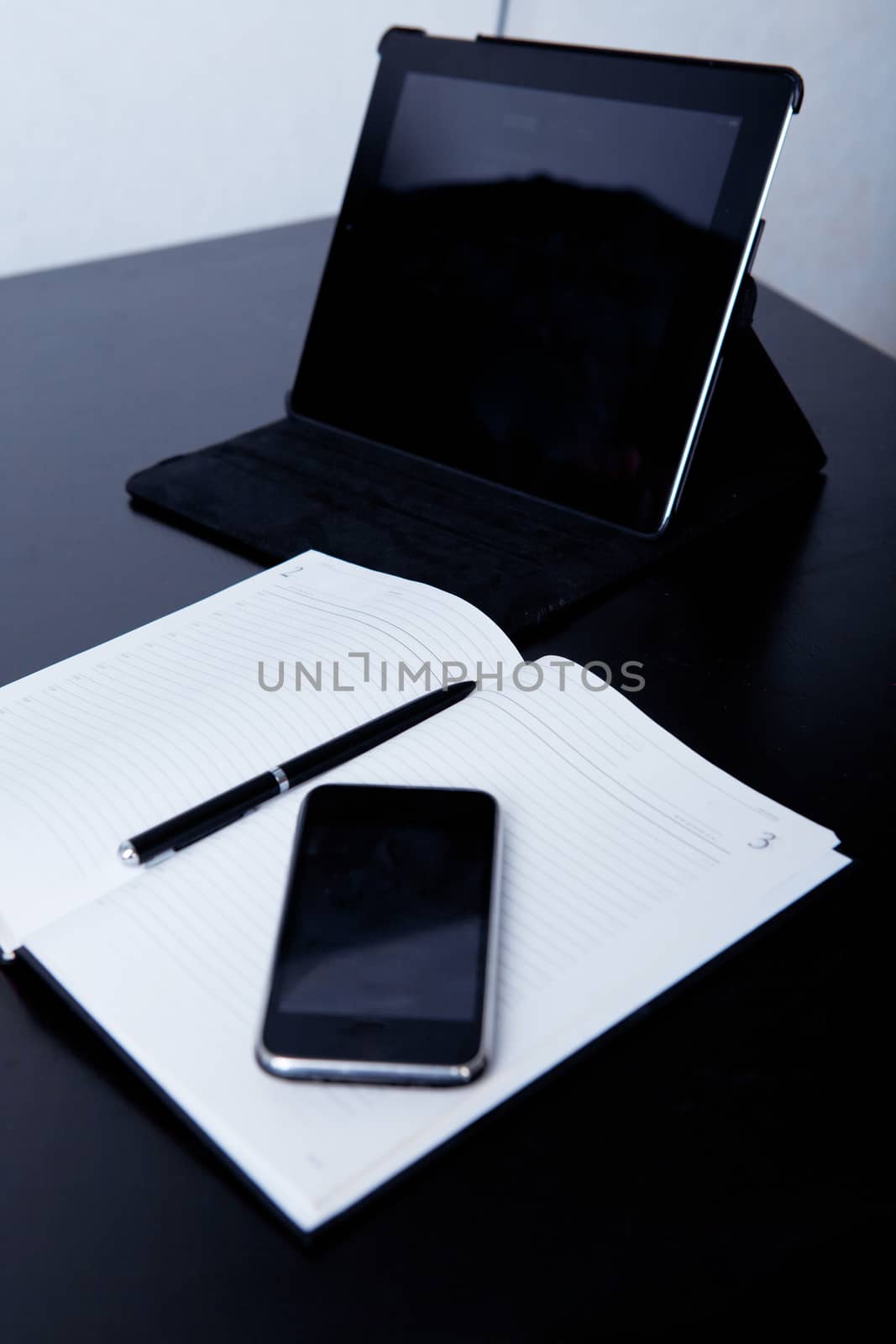 Workplace business person: diary, on the background of the phone and tablet