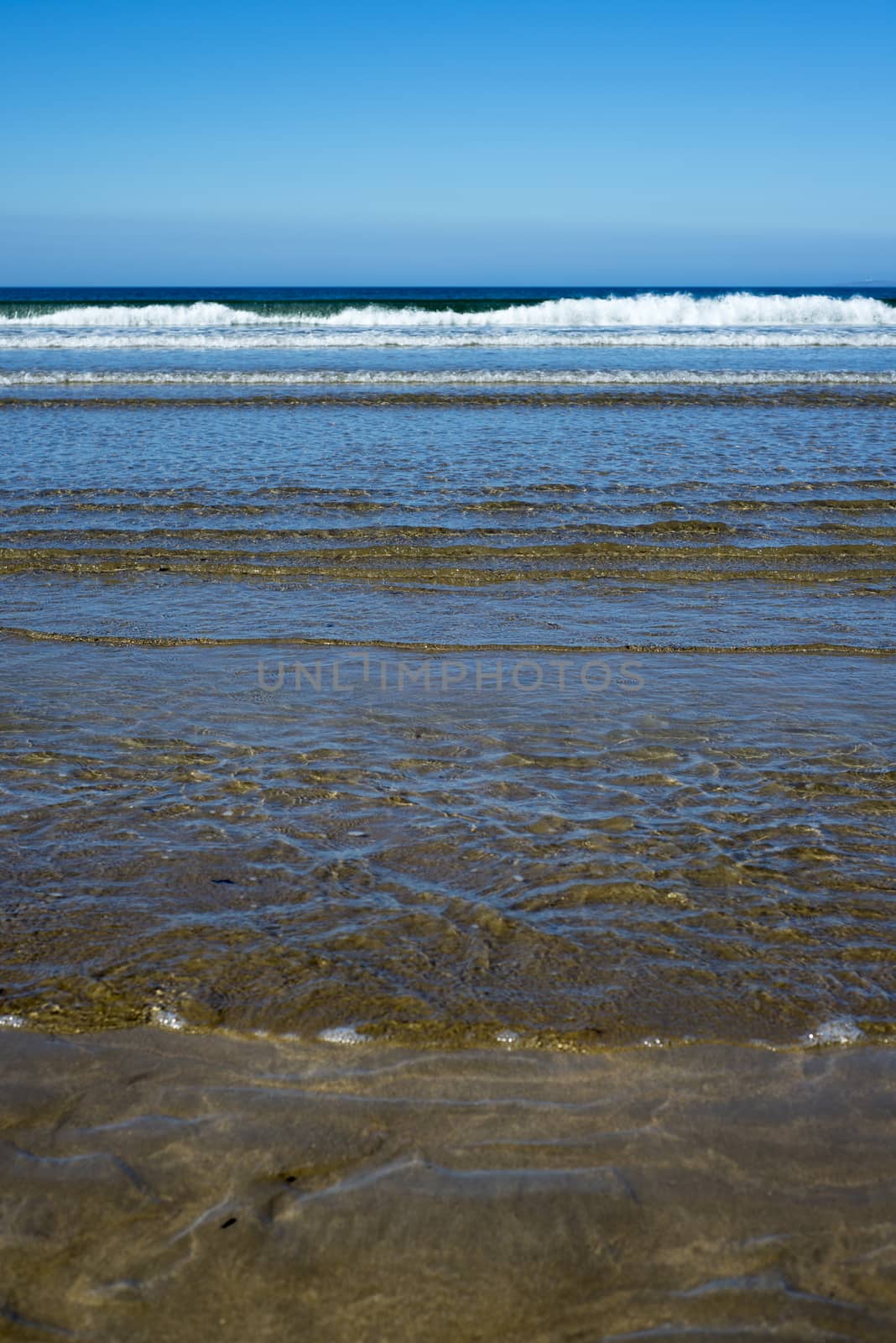 gentle waves lashing onto ballybunion beach by morrbyte