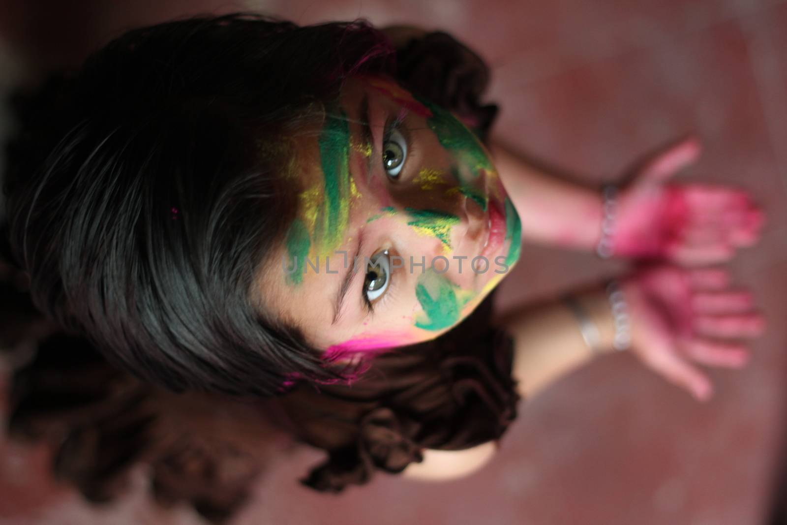 INDIA, Allahabad: A child wears vibrantly colored paints during Holi celebrations in Allahabad, India on March 24, 2016. Hindu devotees splatter each other with paint during Holi celebrations to mark the advent of spring. It is celebrated across the country and in many other countries in the region.