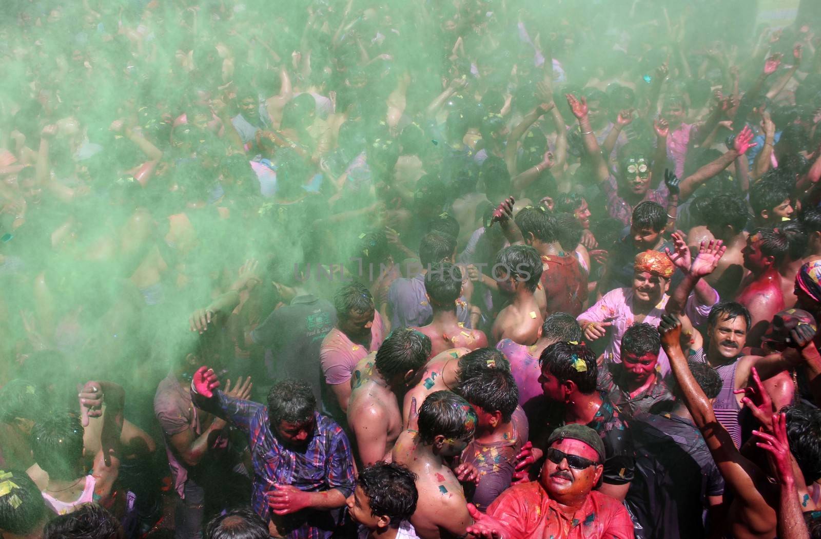 INDIA, Allahabad: Hindu devotees cover each other with vibrantly colored paints during Holi celebrations in Allahabad, India on March 24, 2016. The massive Hindu festival of colors marks the advent of spring, and is celebrated across the country and in many other countries in the region.