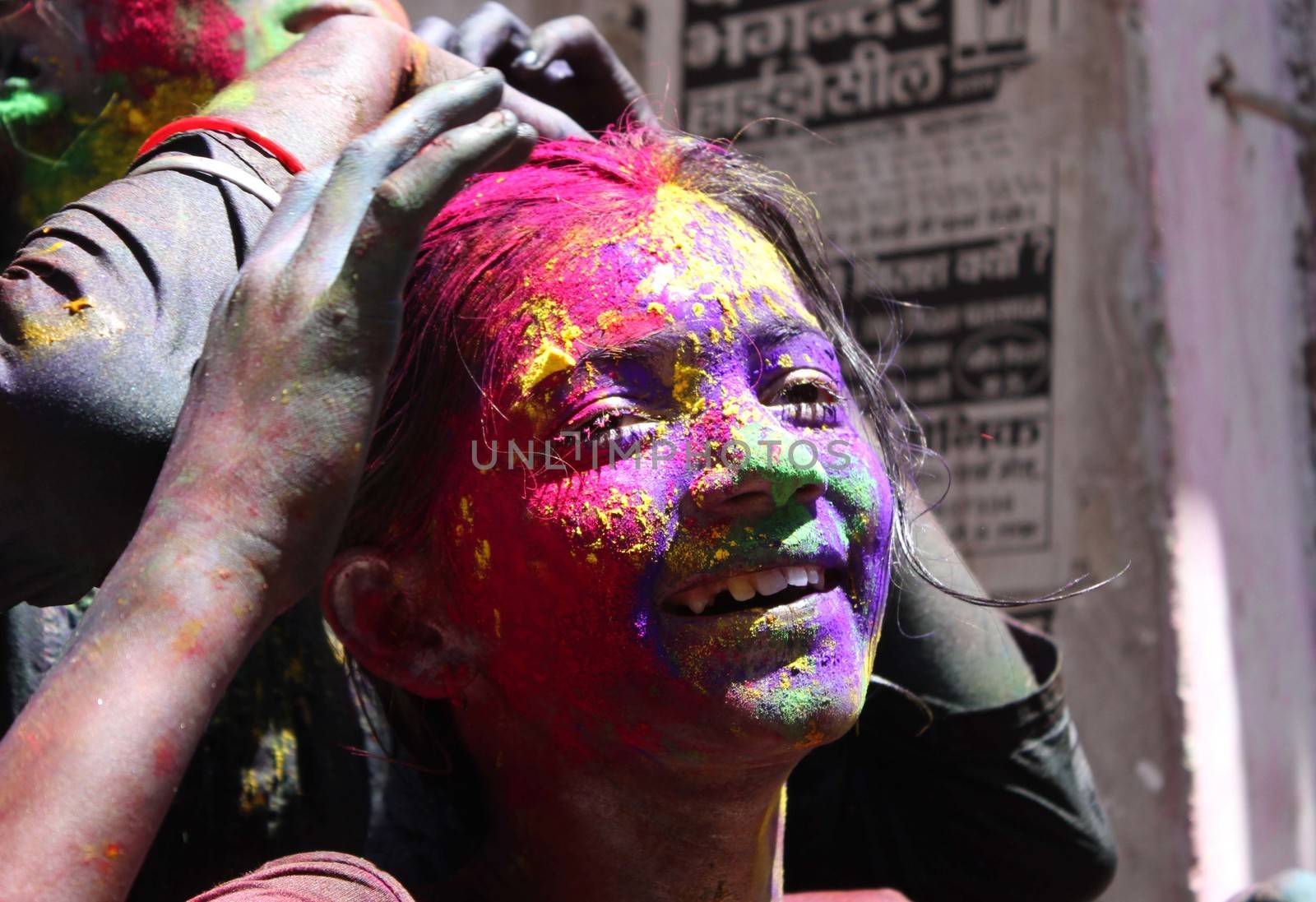 INDIA, Allahabad: A child wears vibrantly colored paints during Holi celebrations in Allahabad, India on March 24, 2016. Hindu devotees splatter each other with paint during Holi celebrations to mark the advent of spring. It is celebrated across the country and in many other countries in the region.
