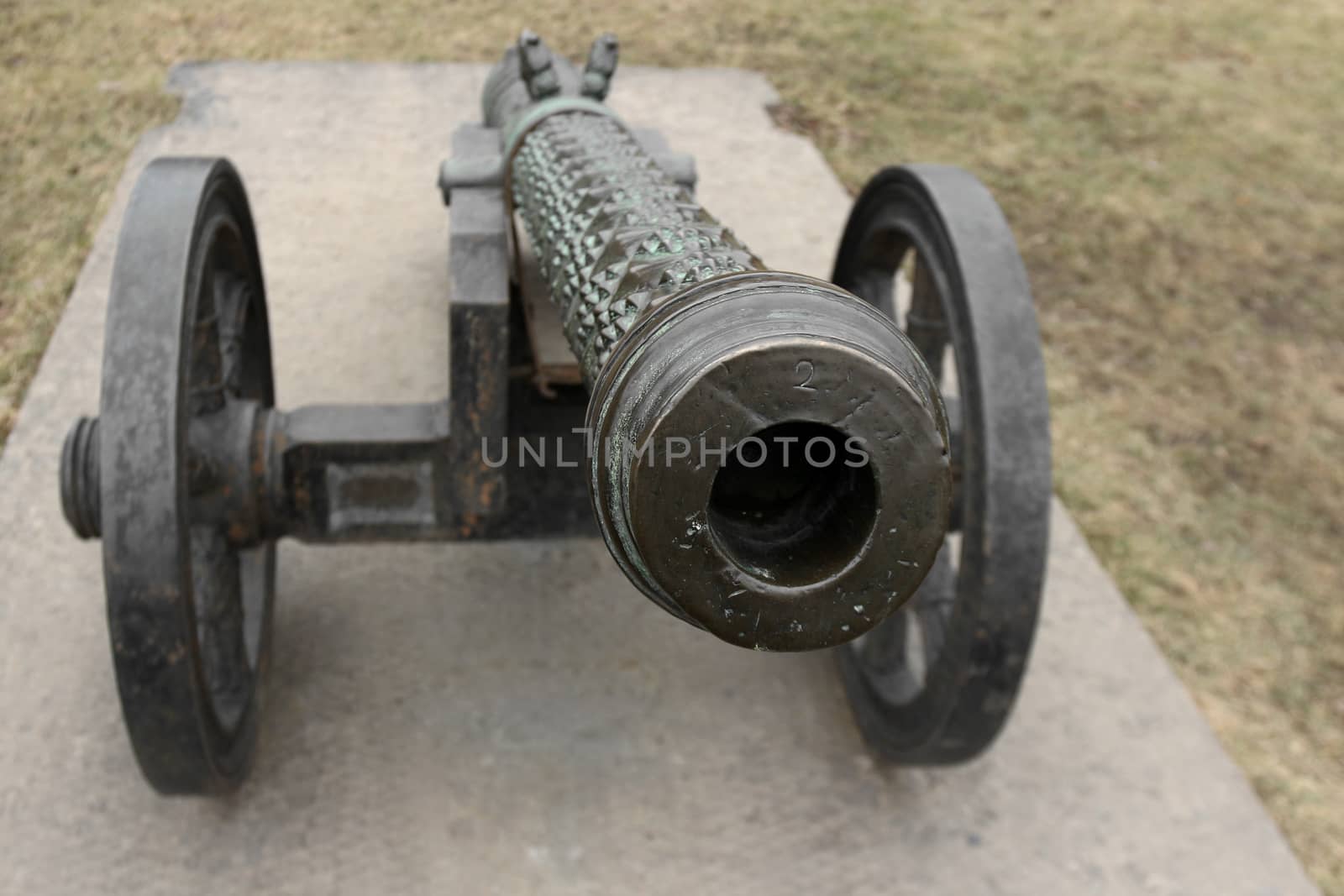 old medieval bronze cannon on the gun carriage front view