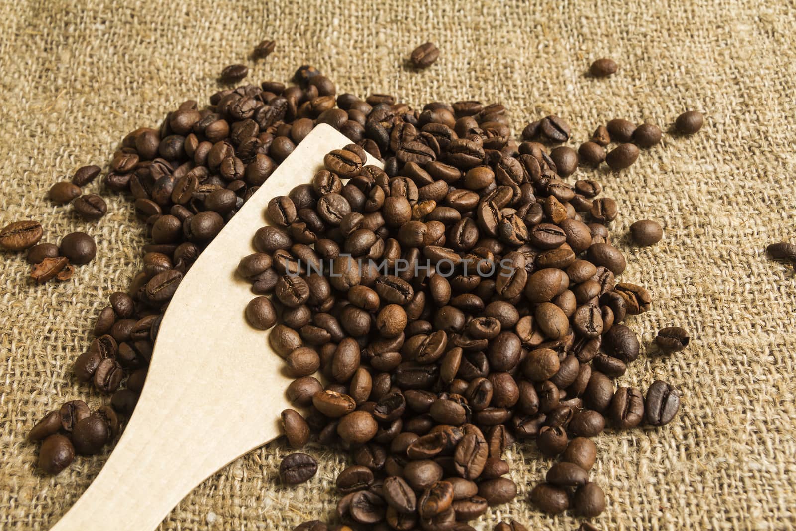 Coffee beans on a wooden spoon
