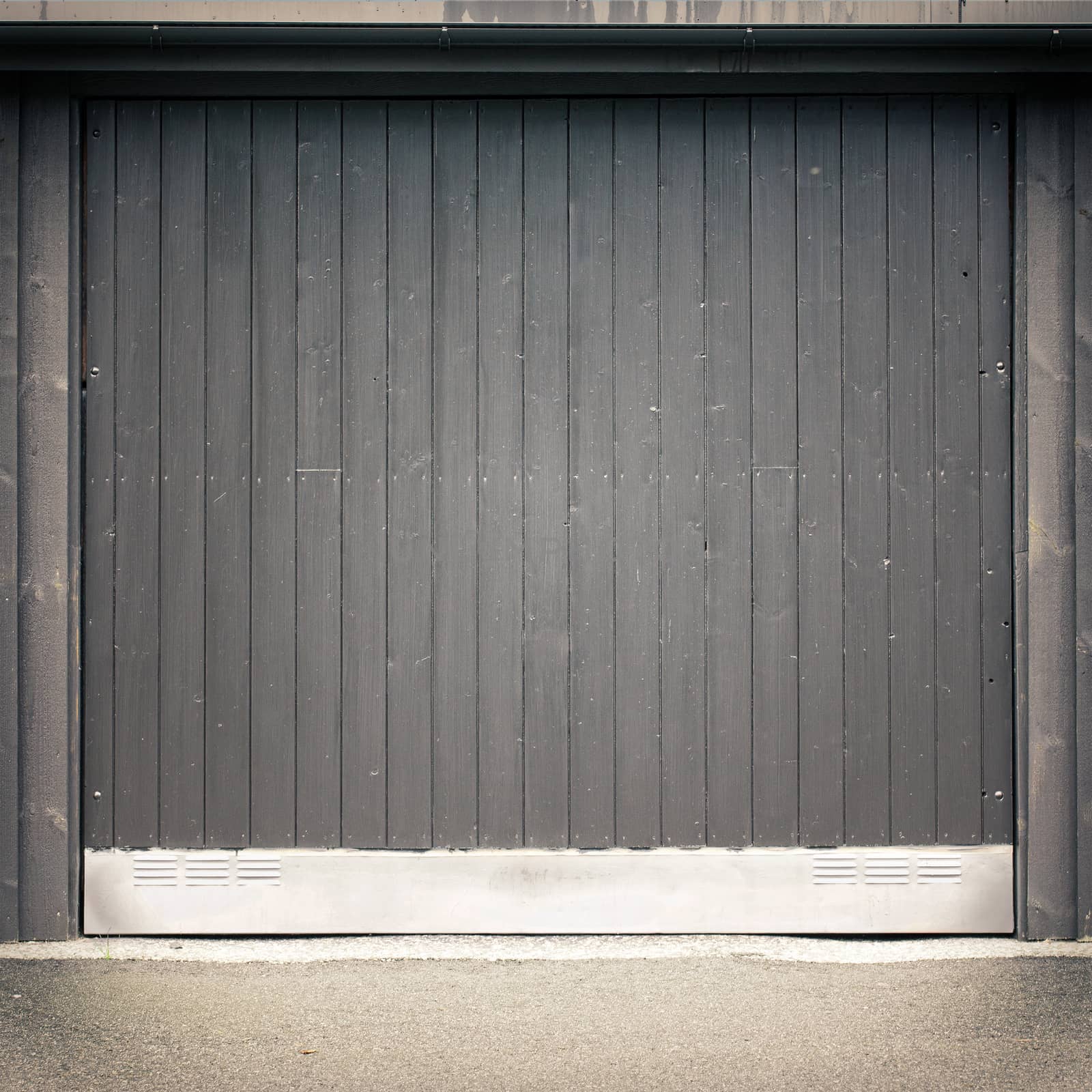 dark black wooden garage door, asphalt ground