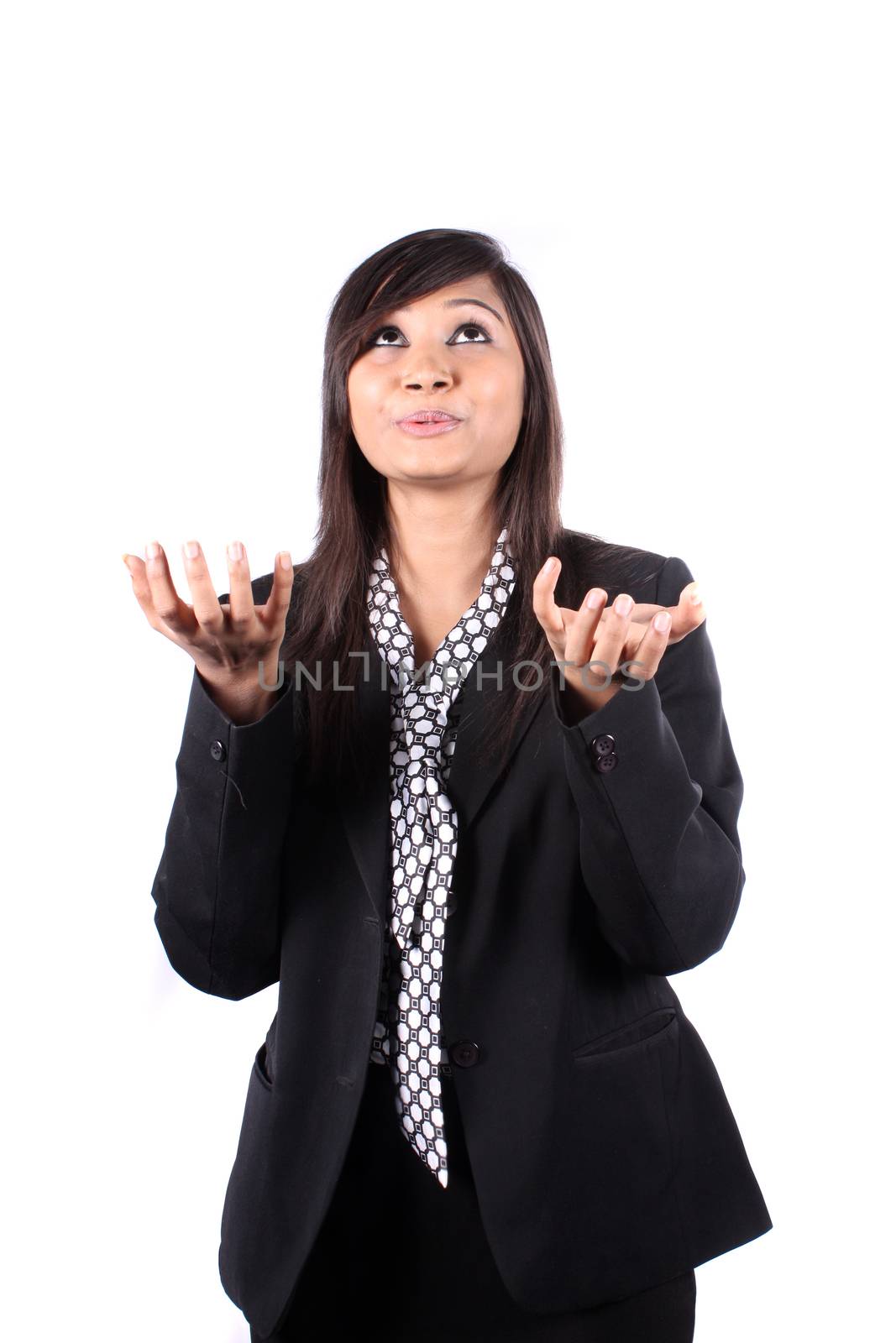 A metaphorical image of a young Indian businesswoman asking where are the profits, on white studio background.