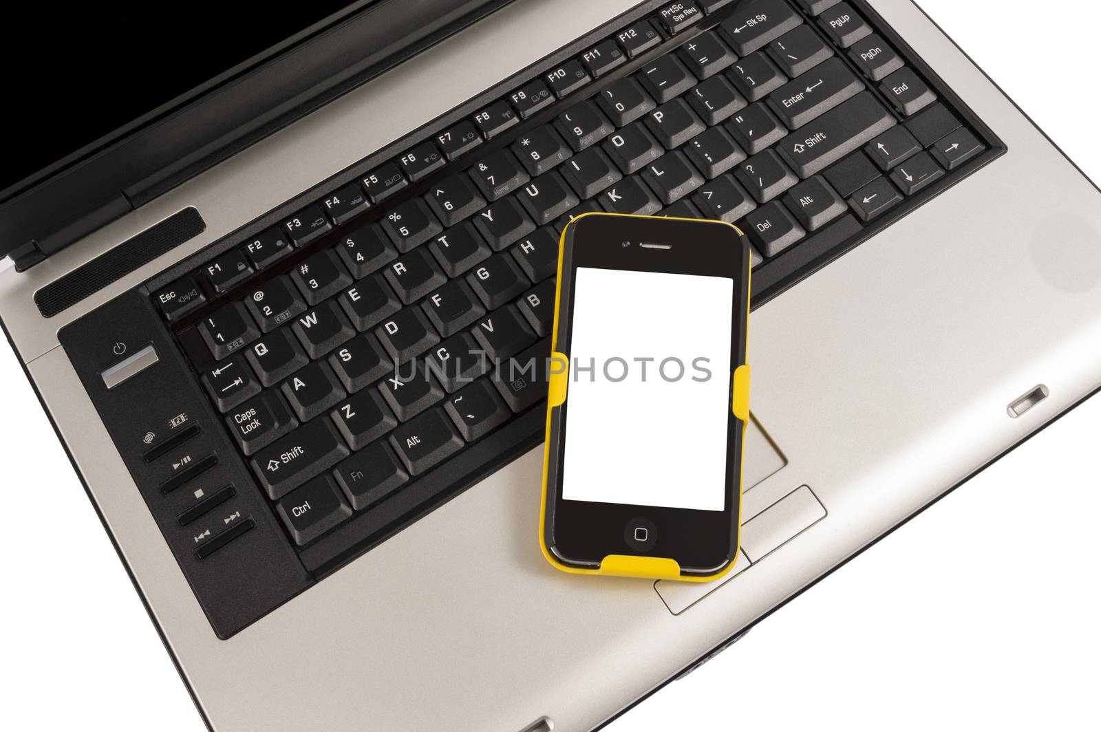Mobile smart phone on a laptop computer keyboard.  Isolated on white.