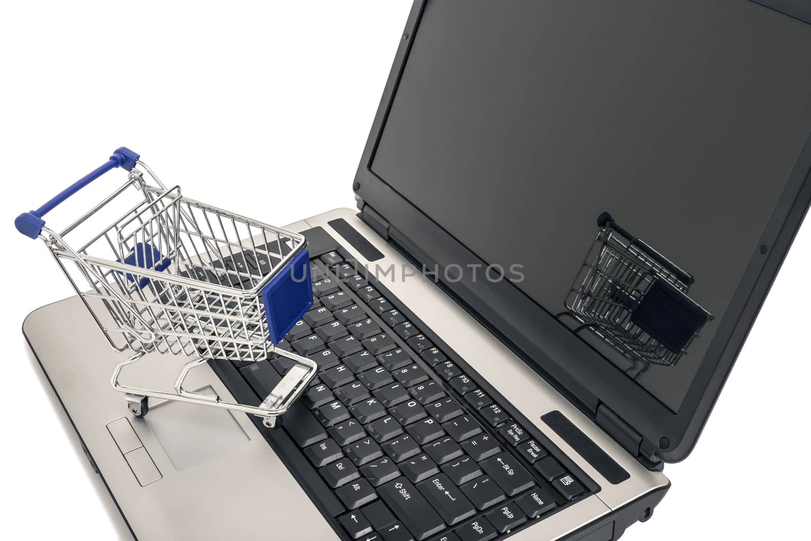 Internet online shopping concept.  Little shopping cart on laptop keyboard.  Isolated on white background.