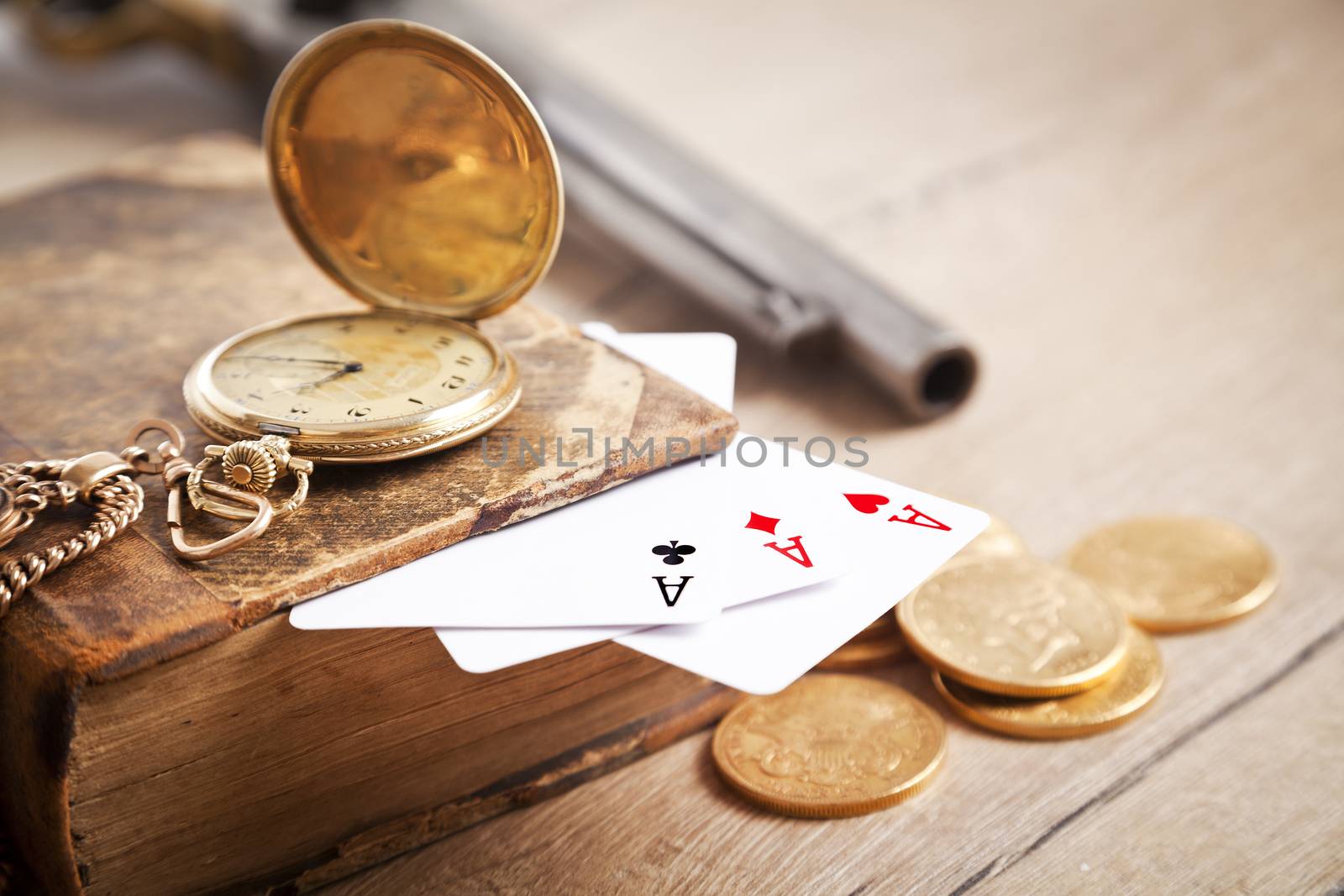 gambling and crime concept with gun, cards and golden coins