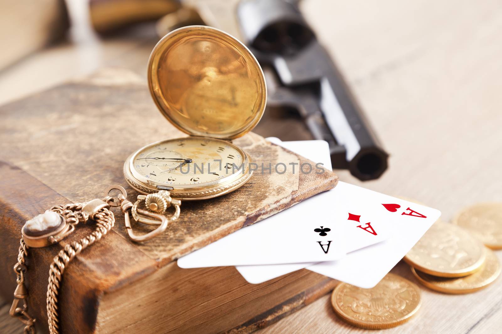 gambling and crime concept with gun, cards and golden coins