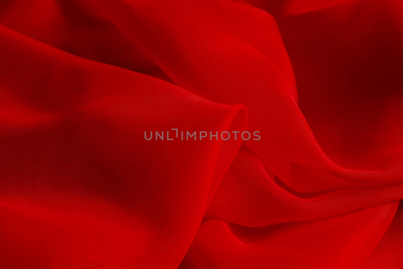 the texture of the red fabric from the delicate chiffon
