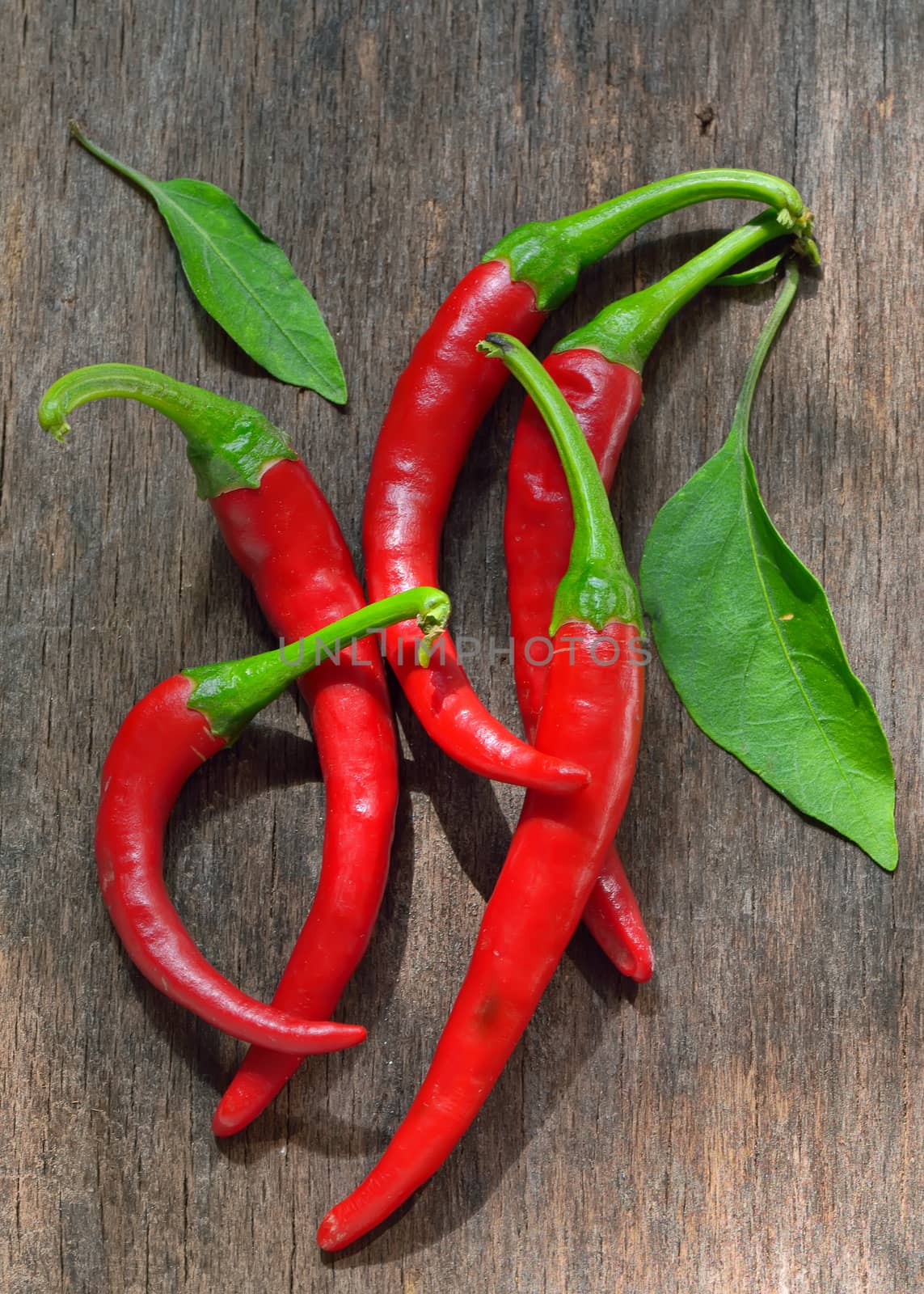 Red Chili Peppers over wooden background