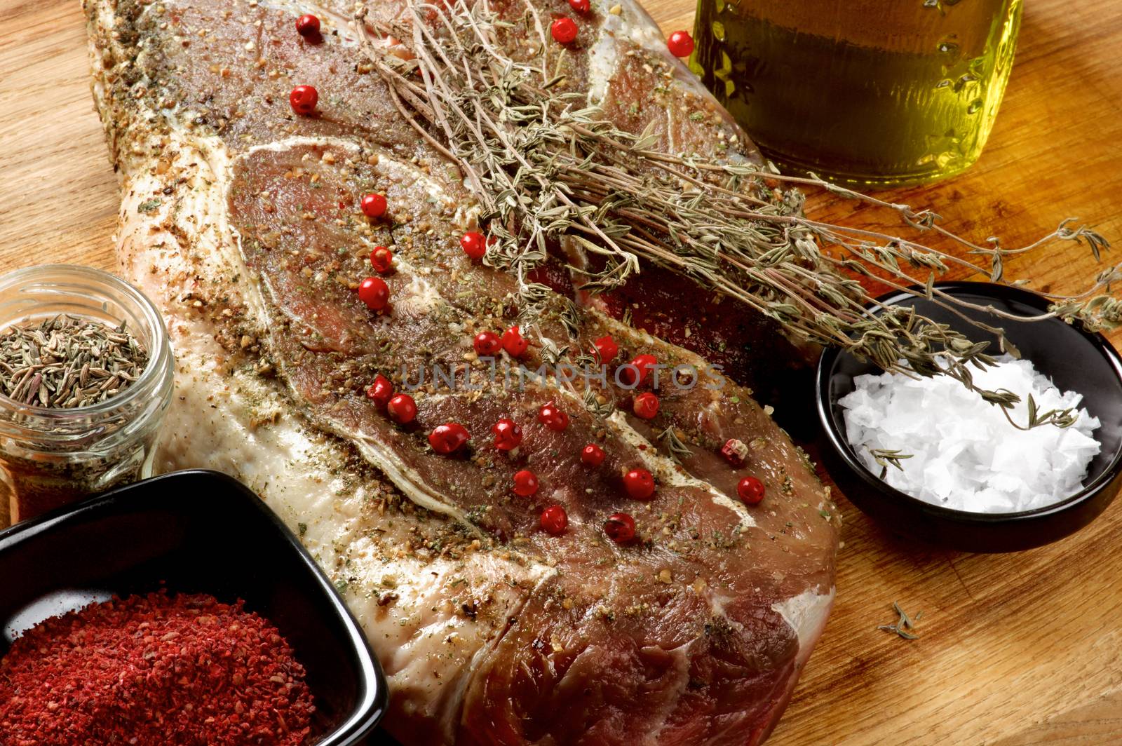 Perfect Big Raw Beef Steak with Spices and Herbs Ready to Roast closeup on Wooden background