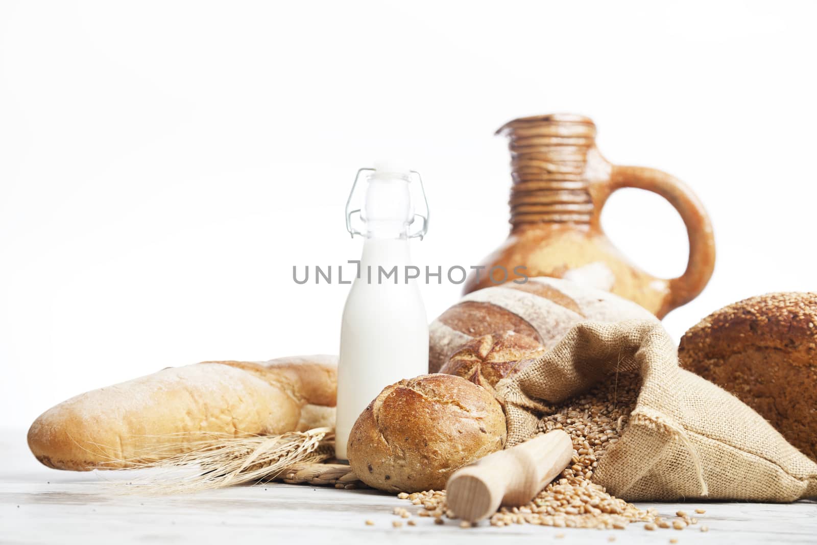 Freshly baked bread,honey and eggs on wooden vintage table