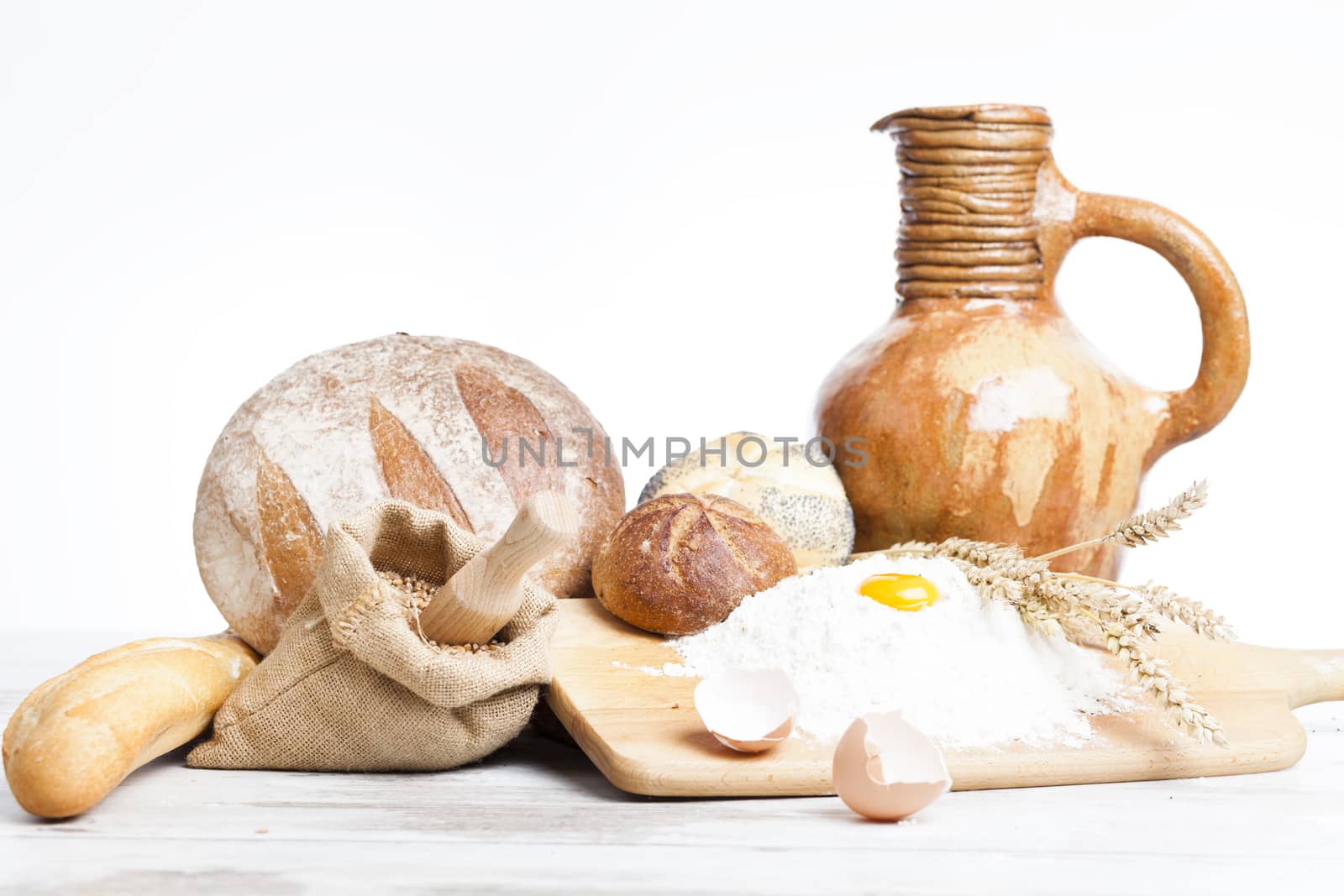 Freshly baked bread rolls, wheat ears and honey