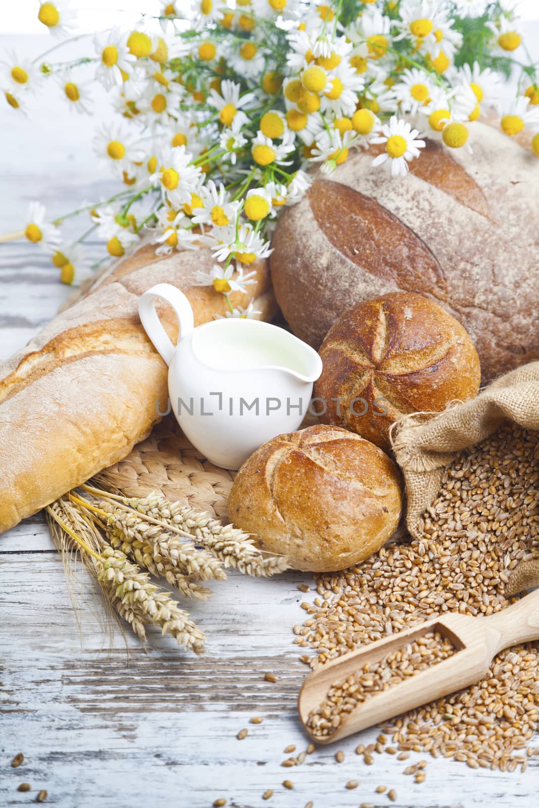 Freshly baked bread rolls, wheat ears and honey