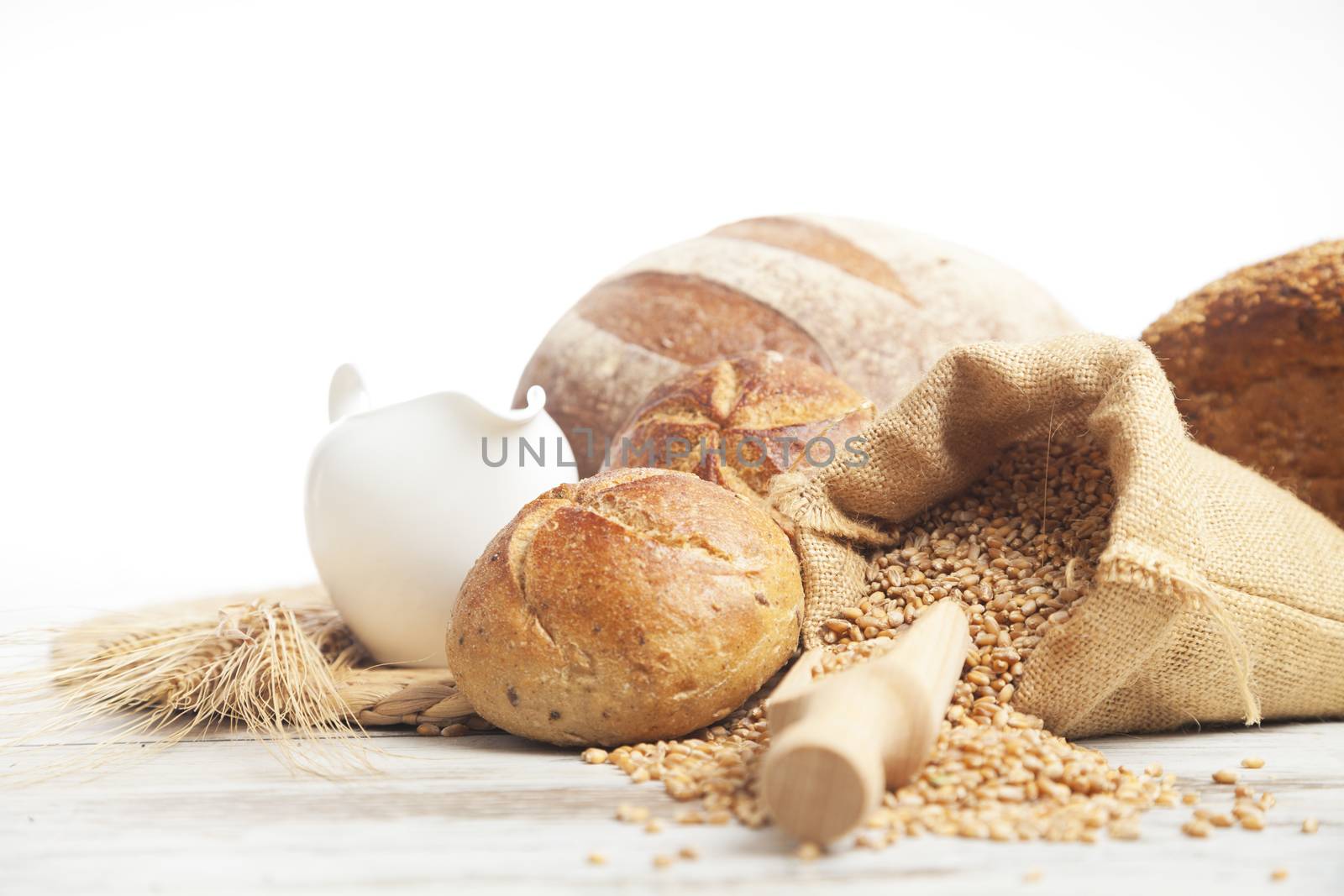 Freshly baked bread rolls, wheat ears and honey