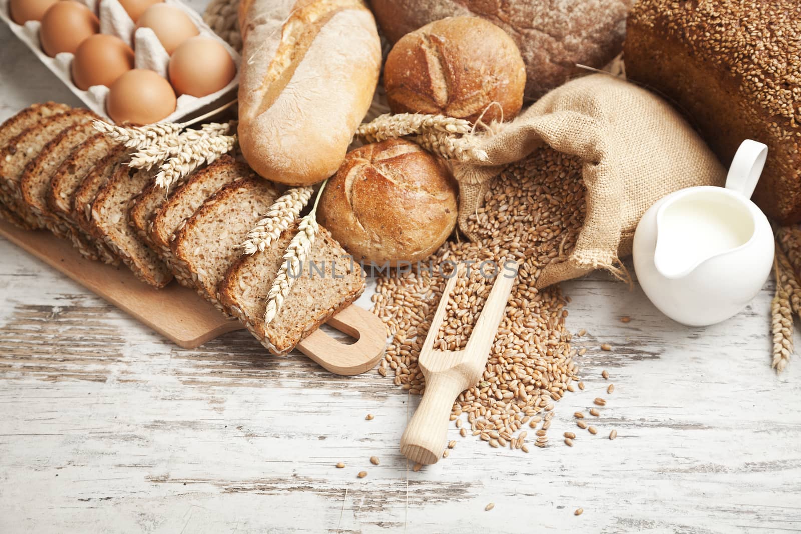 Freshly baked bread rolls, wheat ears and honey