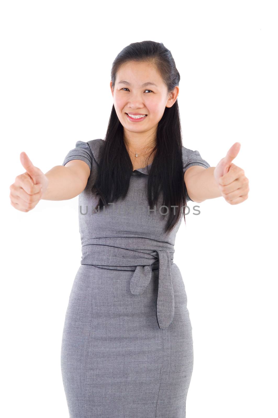 Thumbs up asia businesswoman giving thumbs up over 