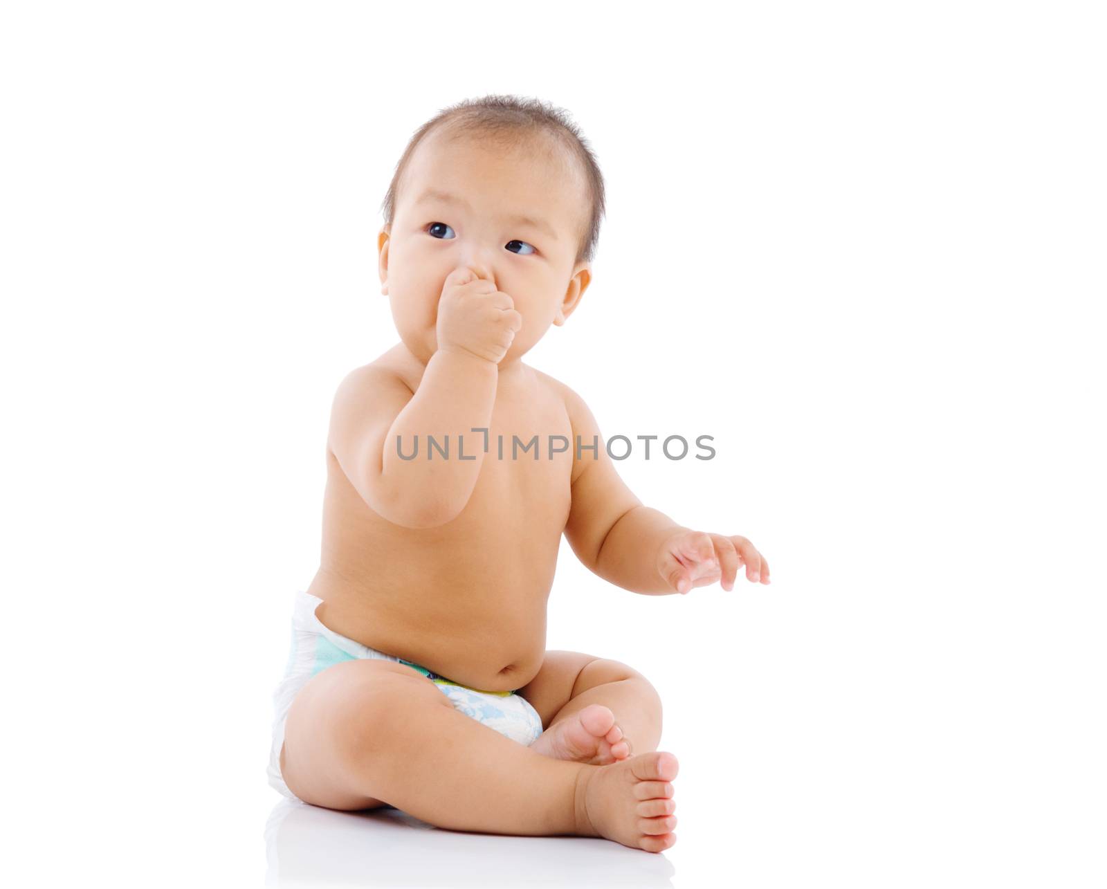 cute asian baby sitting on the floor isolated on white background