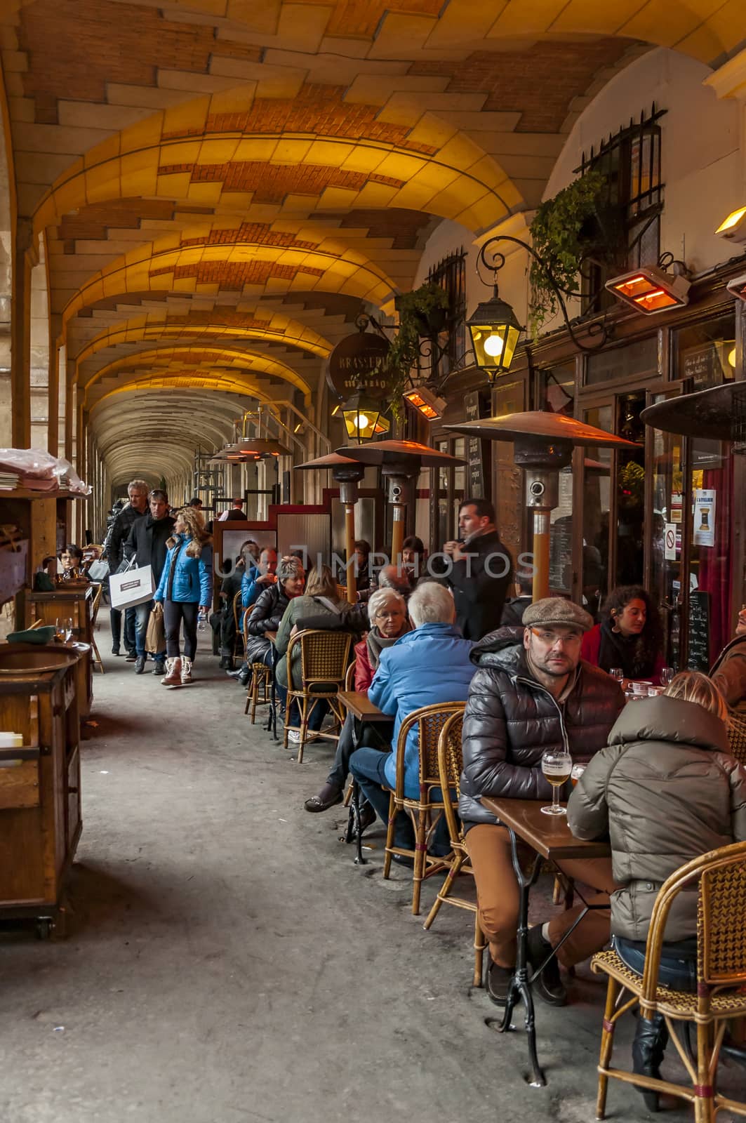 PARIS - MARCH 2: typical Paris cafe with people that enjoy dinner on March 2, 2014 in Paris, France