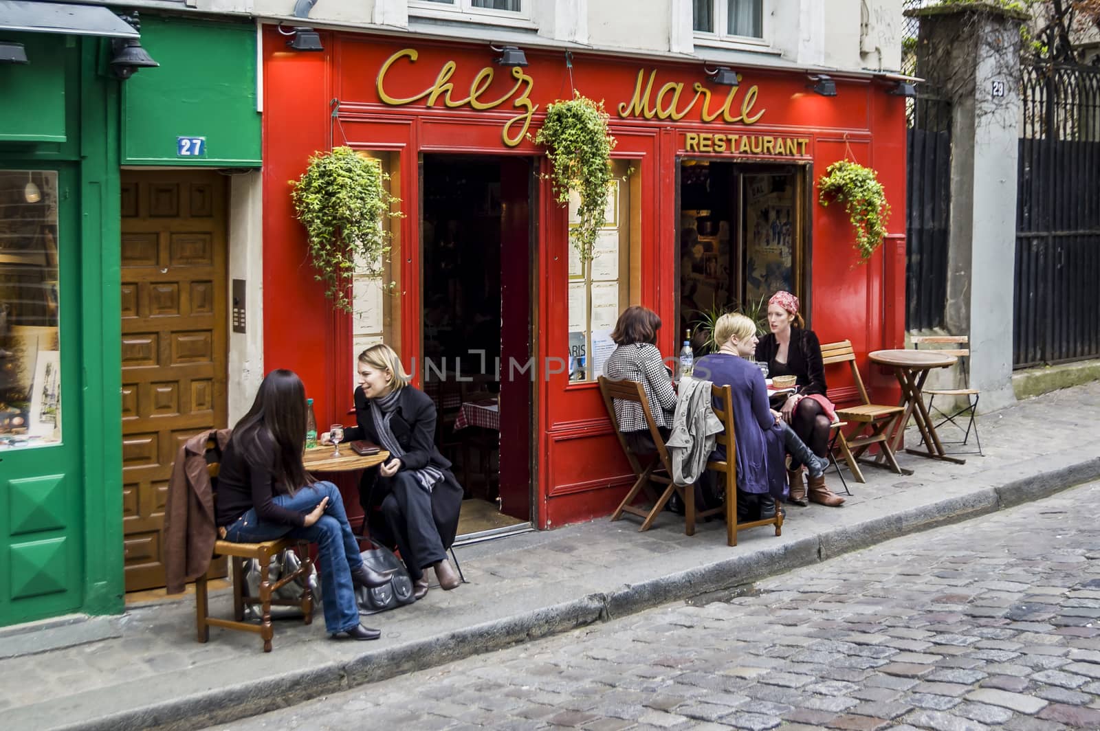 PARIS - MARCH 2: typical Paris cafe with people that enjoy dinner on March 2, 2014 in Paris, France