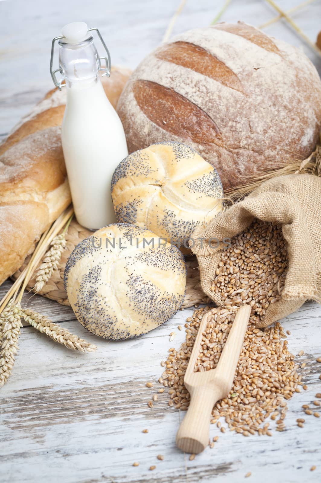 Freshly baked bread rolls, wheat ears and honey