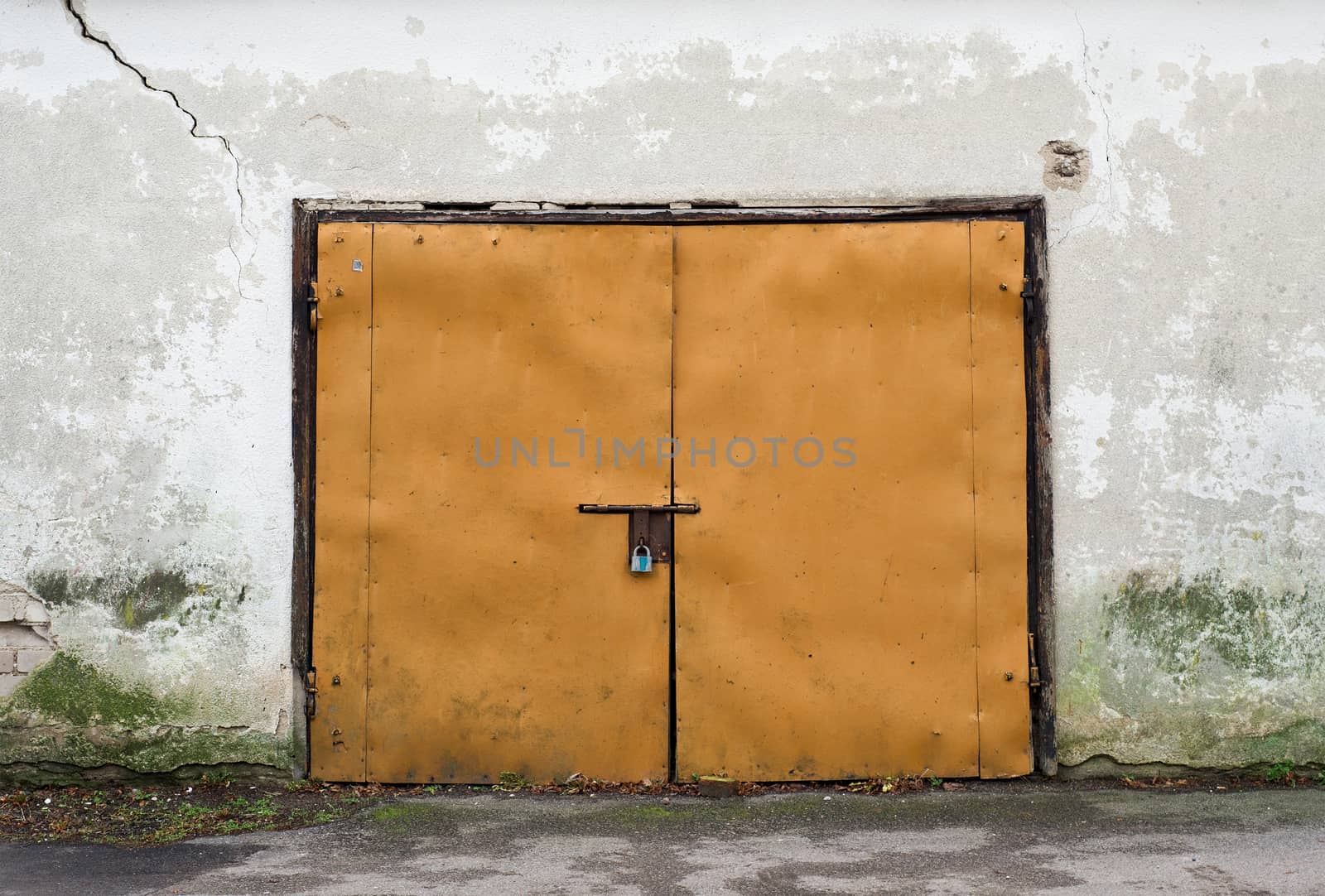 metal door of garage, grunge stucco wall