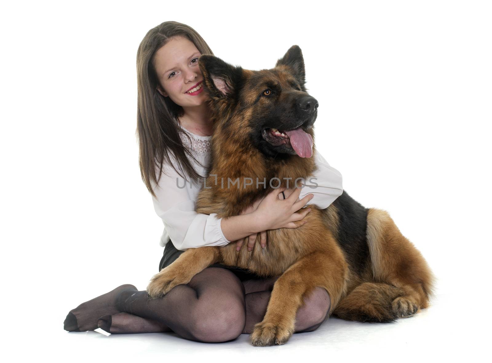 teenager and adult german shepherd in front of white background