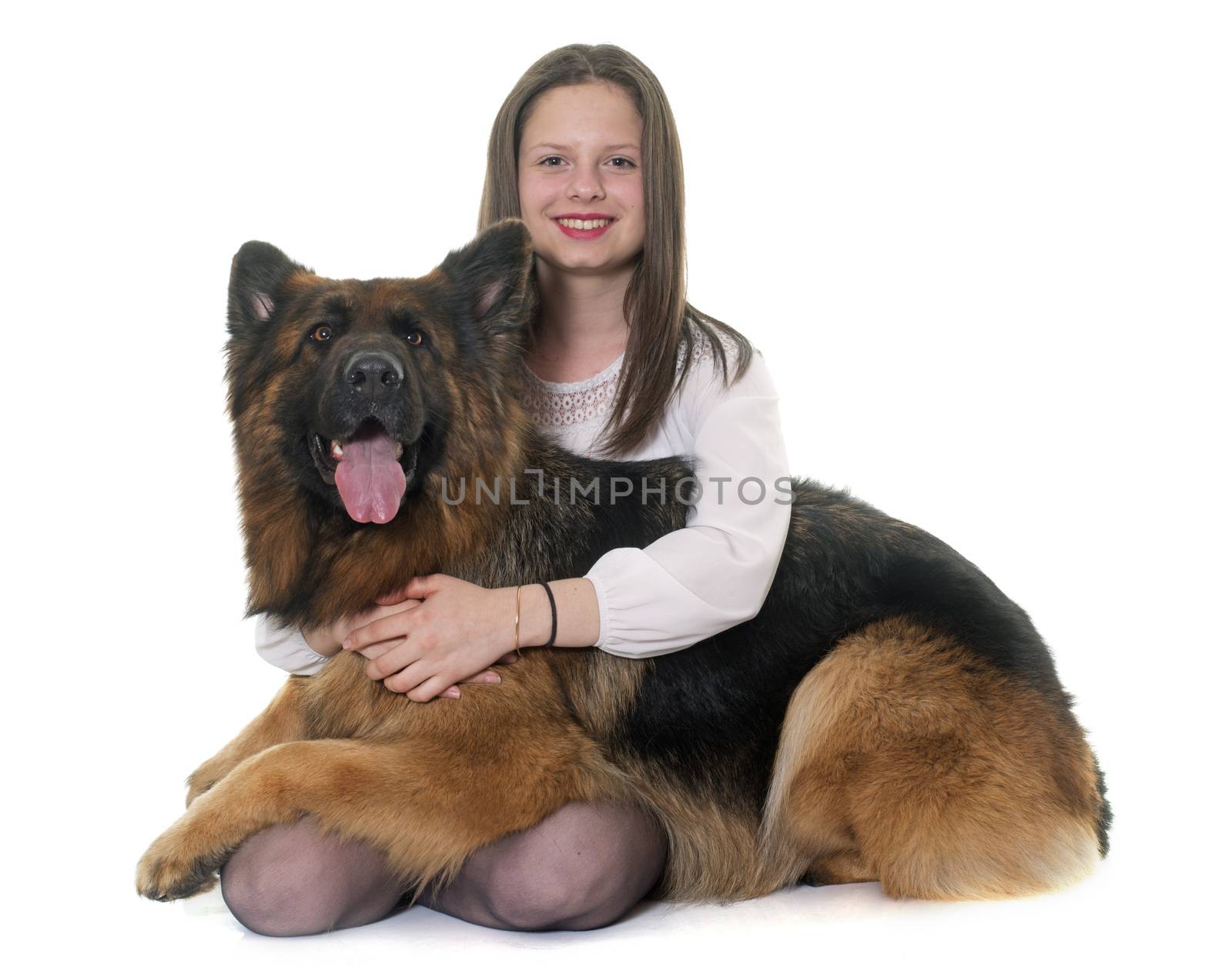 teenager and adult german shepherd in front of white background