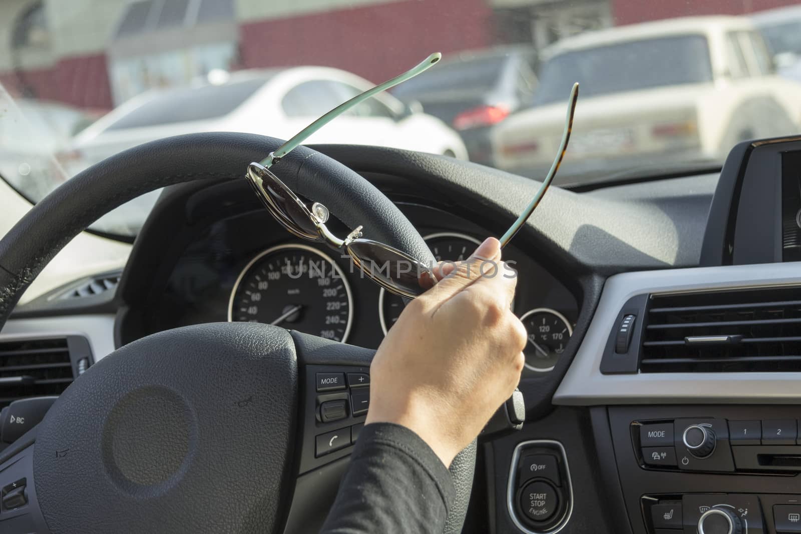 the girl behind the wheel of the car keeps sunglasses