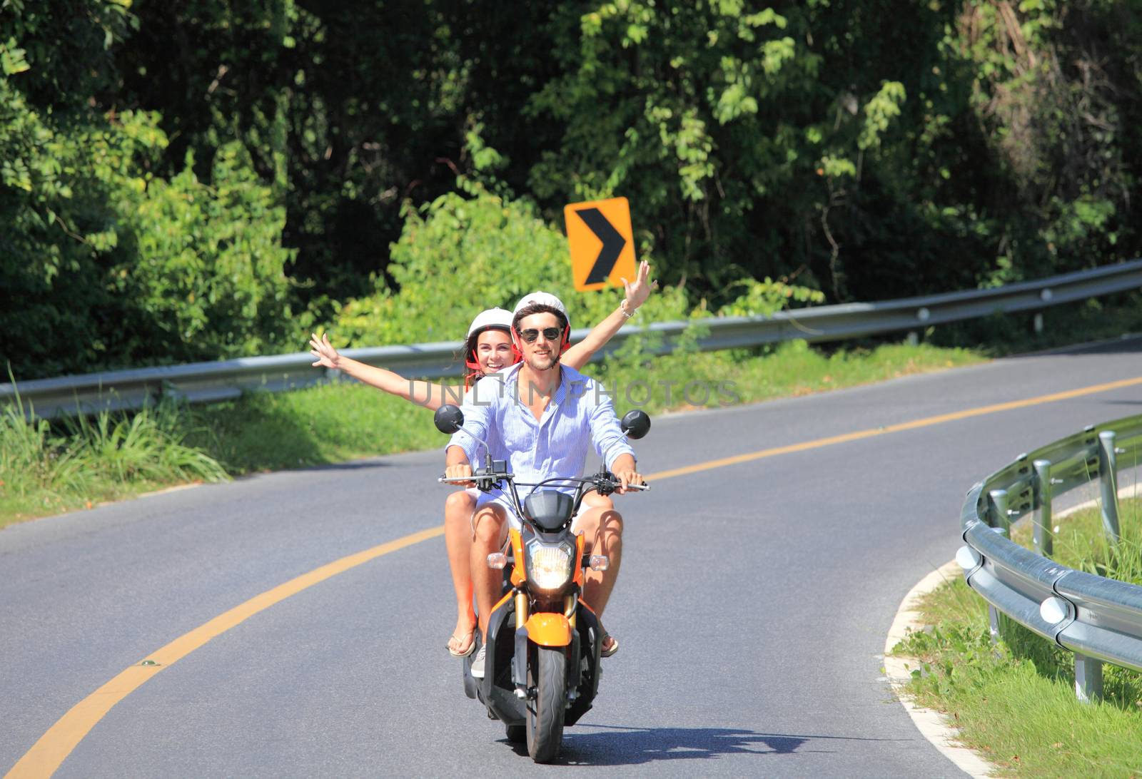 Happy couple on a scooter at summer vacation