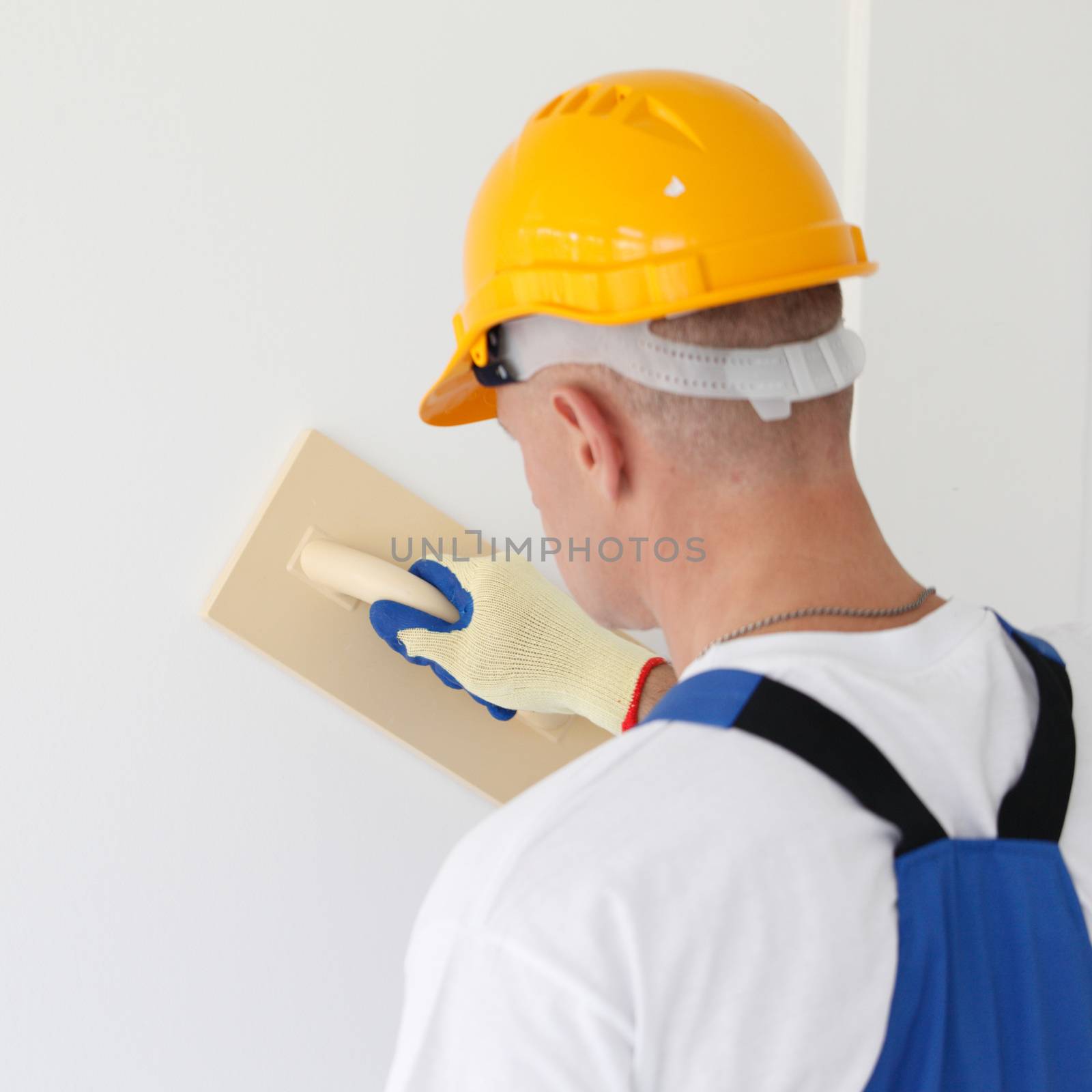 Plasterer polishing the wall by ALotOfPeople