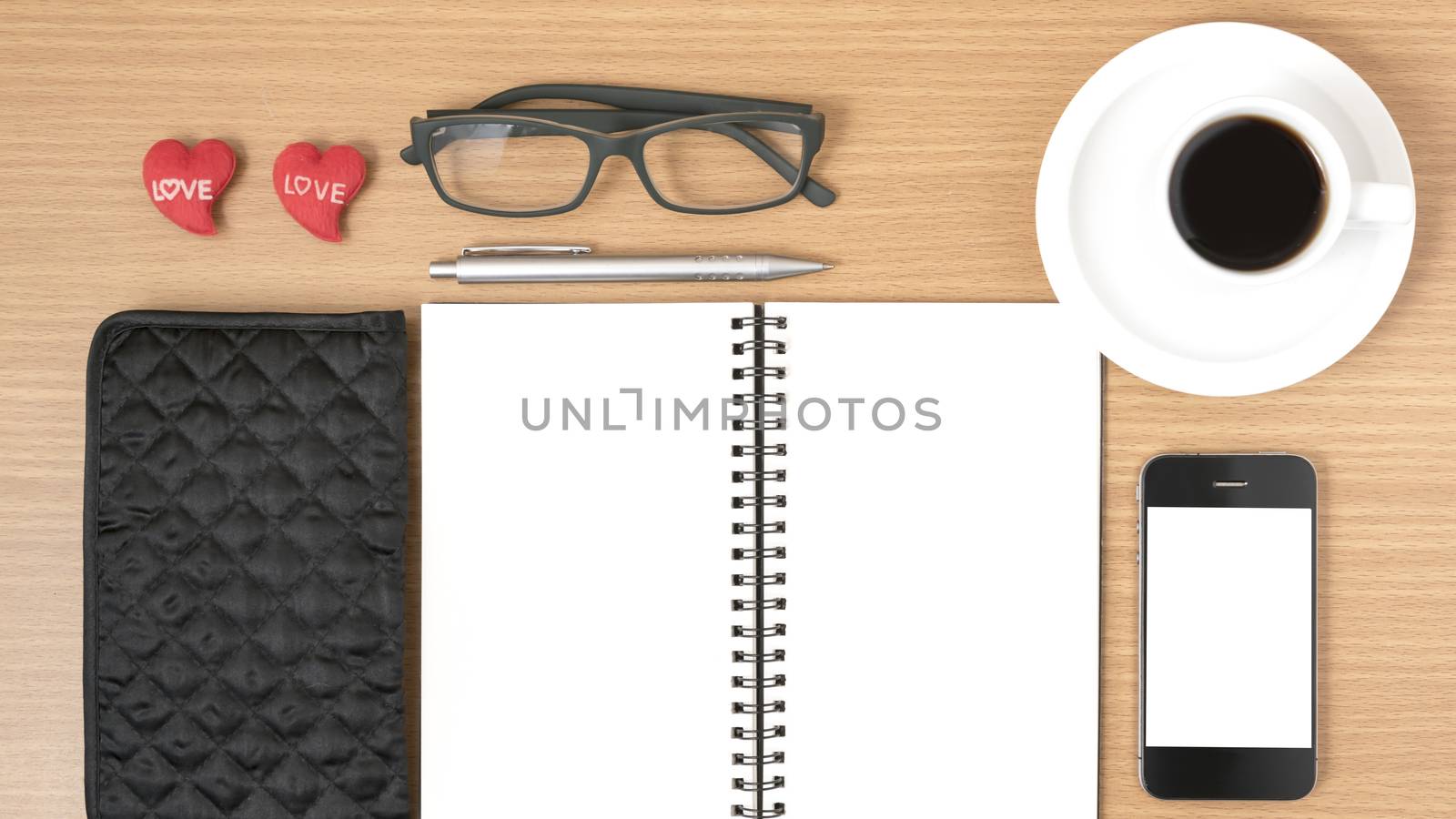 office desk : coffee with phone,notepad,eyeglasses,wallet,heart on wood background