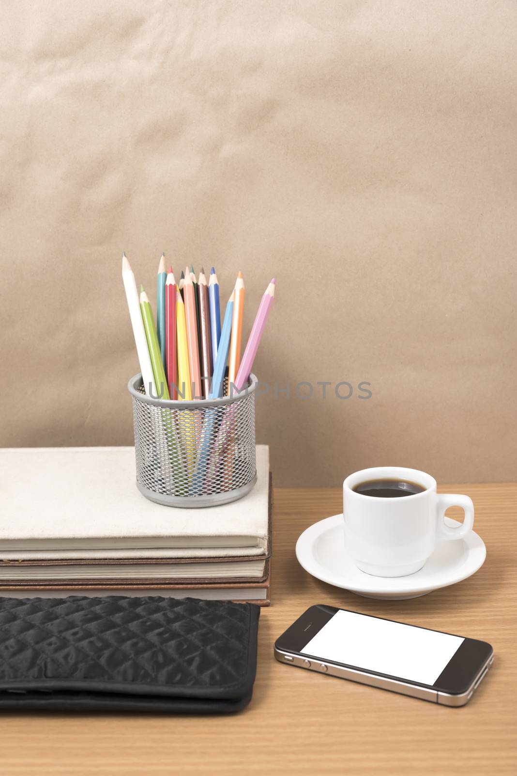 office desk : coffee with phone,stack of book,wallet,color box on wood background