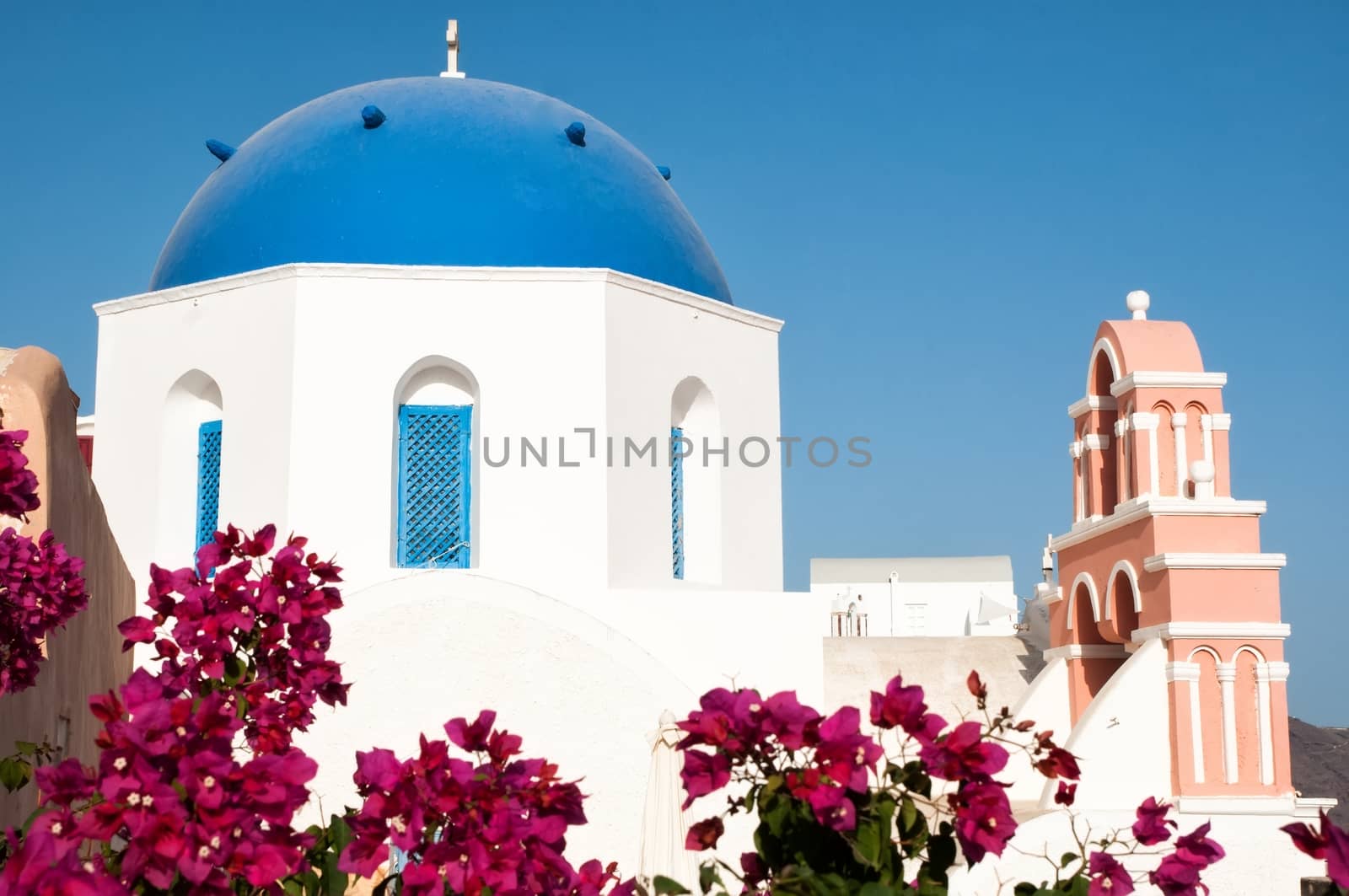 Iconic blue domed church in Fira, Santorini by mitakag